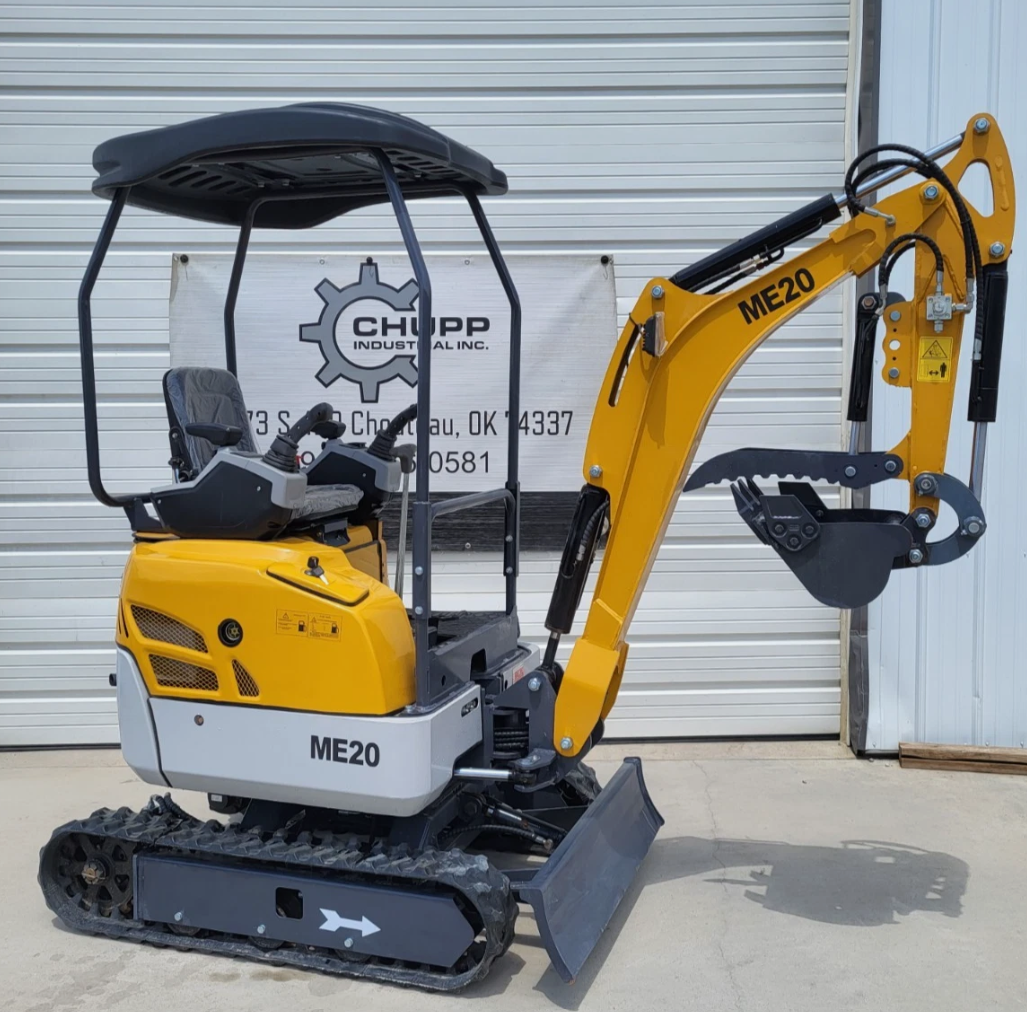 ME20 mini excavator in side profile, yellow boom with bucket and hydraulic thumb, canopy over the seat, rubber tracks