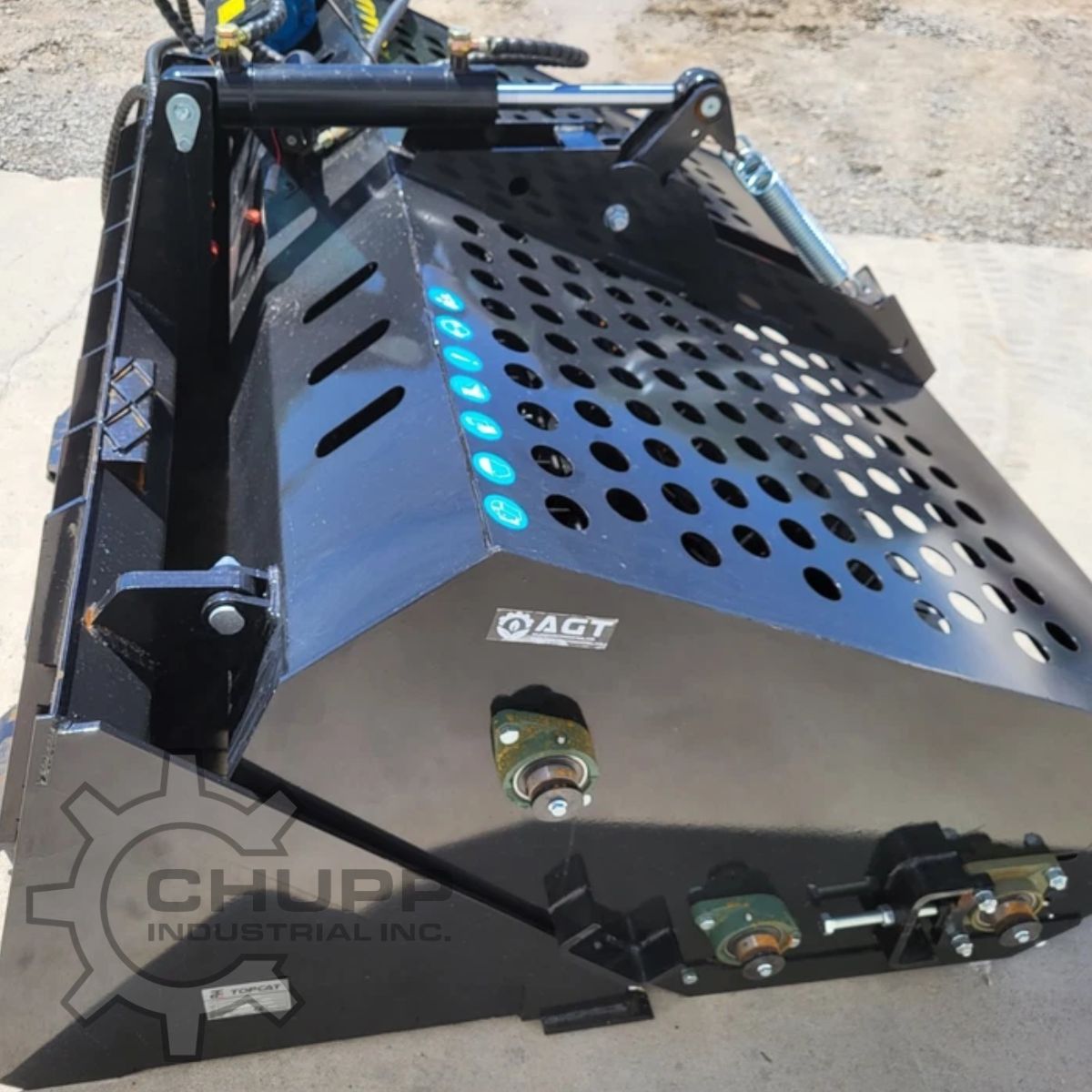 AGT landscape rake with its perforated dump shroud, hydraulic cylinder, tension spring and mounted drive bearings