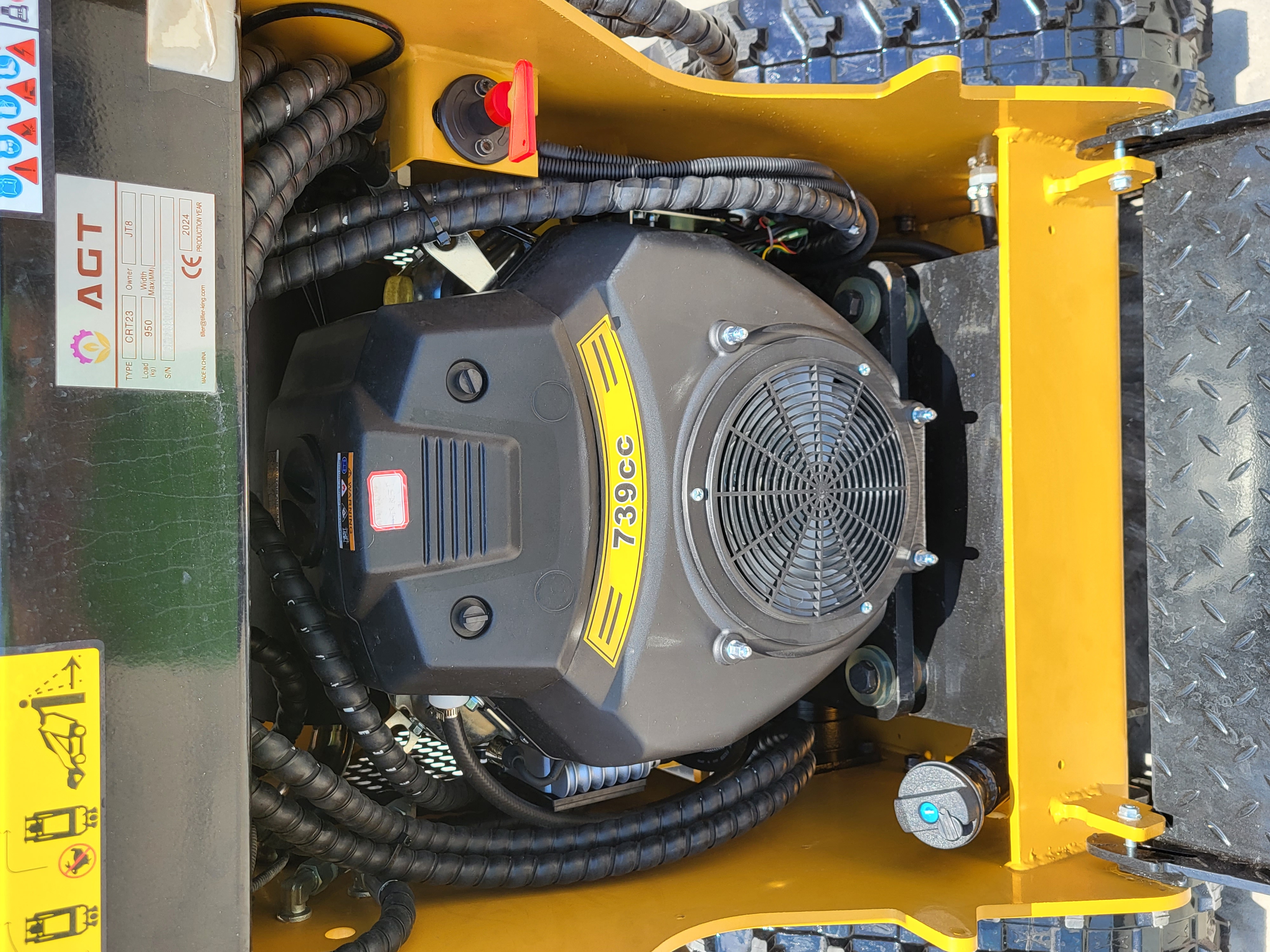 AGT CRT23 739cc gasoline engine with cooling-fan cover, fuel cap and the machine's data plate alongside
