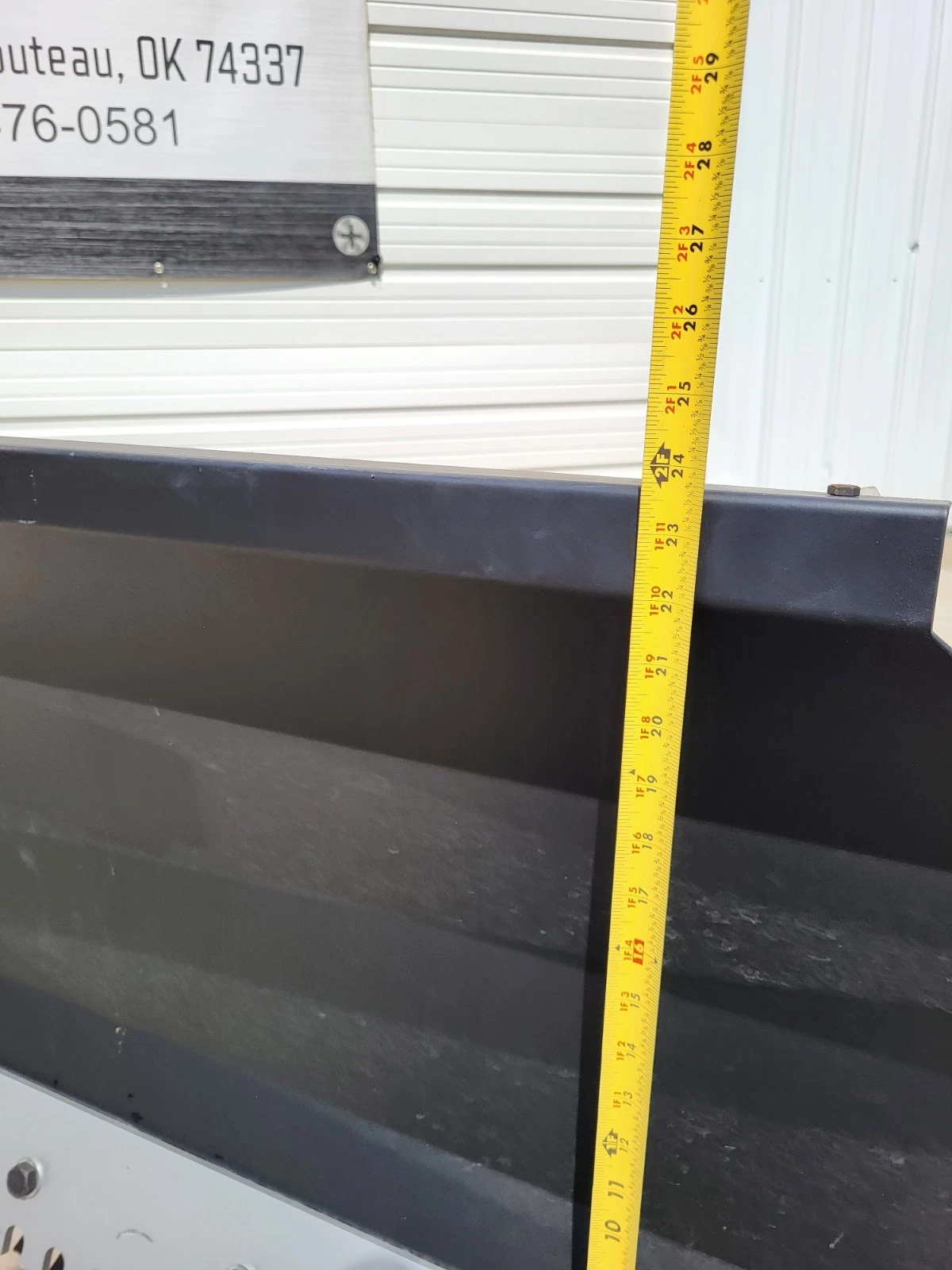 Tape measure at the side of the push blade, reading about 24 inches of height