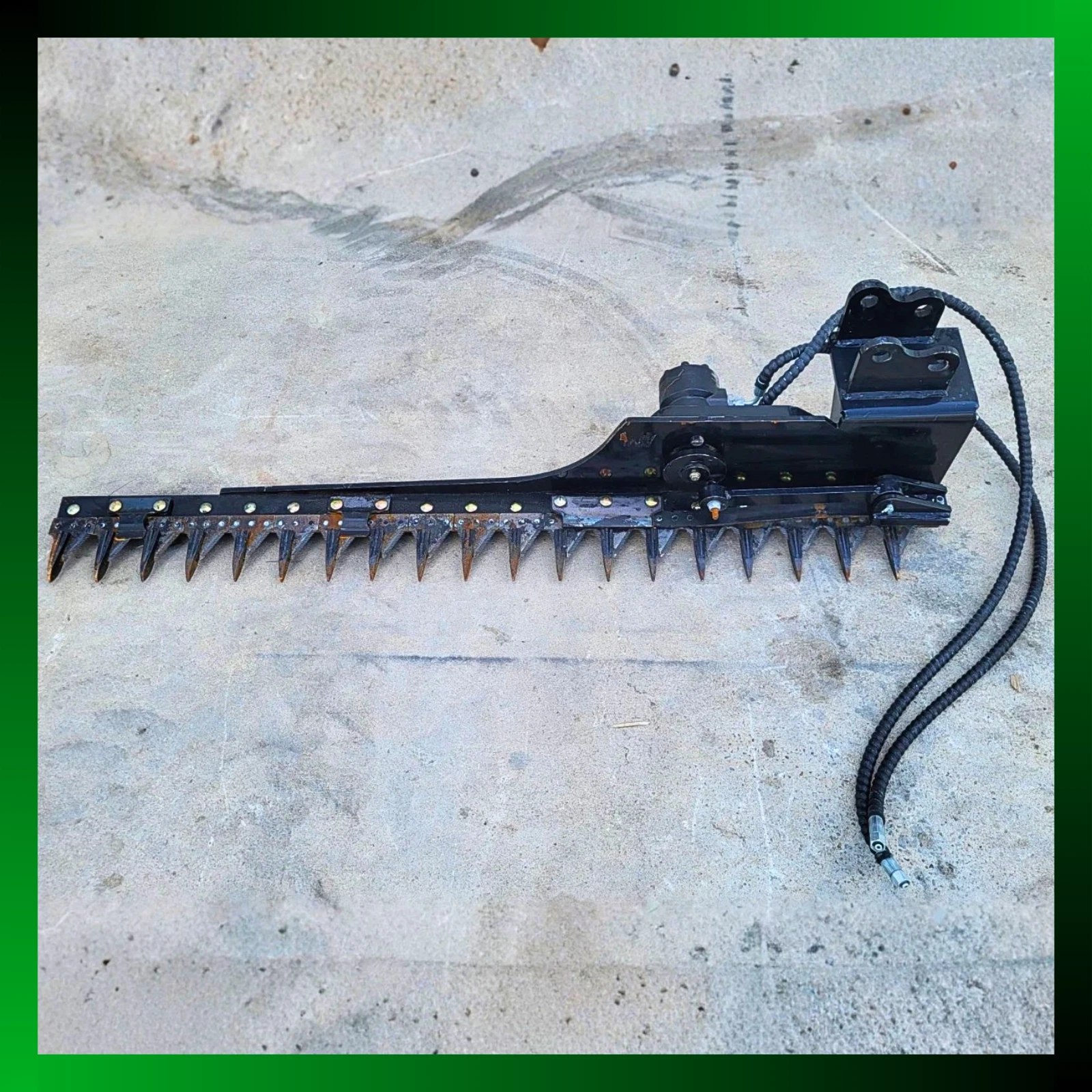 Black 58-inch sickle mower bar, pointed cutter guards, hydraulic drive motor and coiled hoses