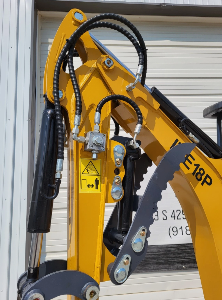 IRE18P yellow boom with hydraulic hose routing, manifold block and serrated hydraulic thumb