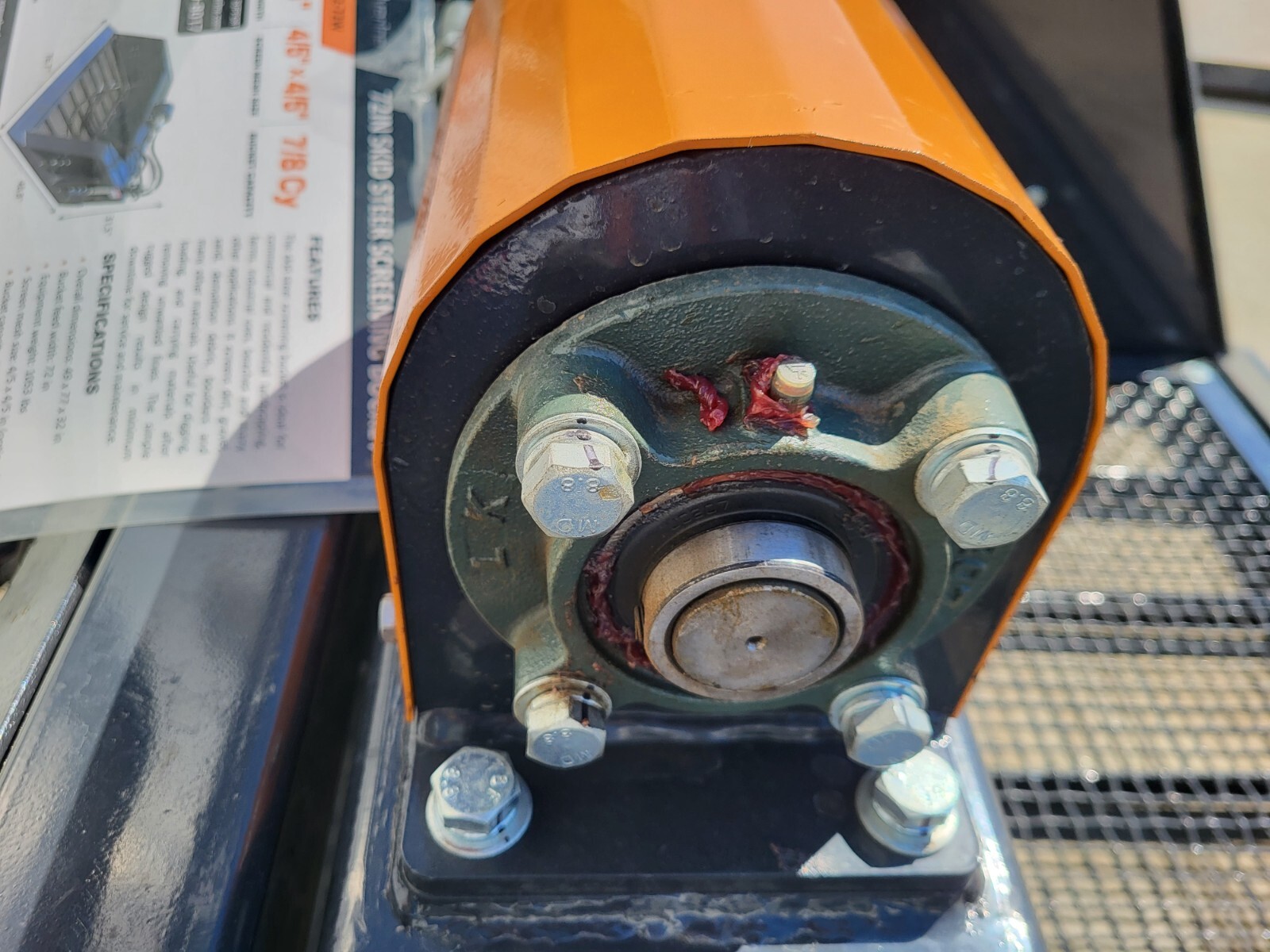 Vibration motor bearing assembly with central drive shaft and mounting bolts.