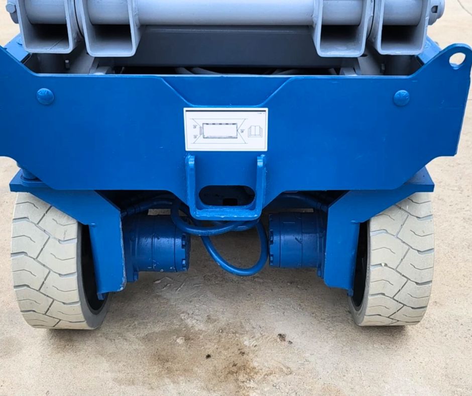 Genie GS-3232 rear drive axle with hydraulic drive motors, solid tires and the scissor stack stowed above