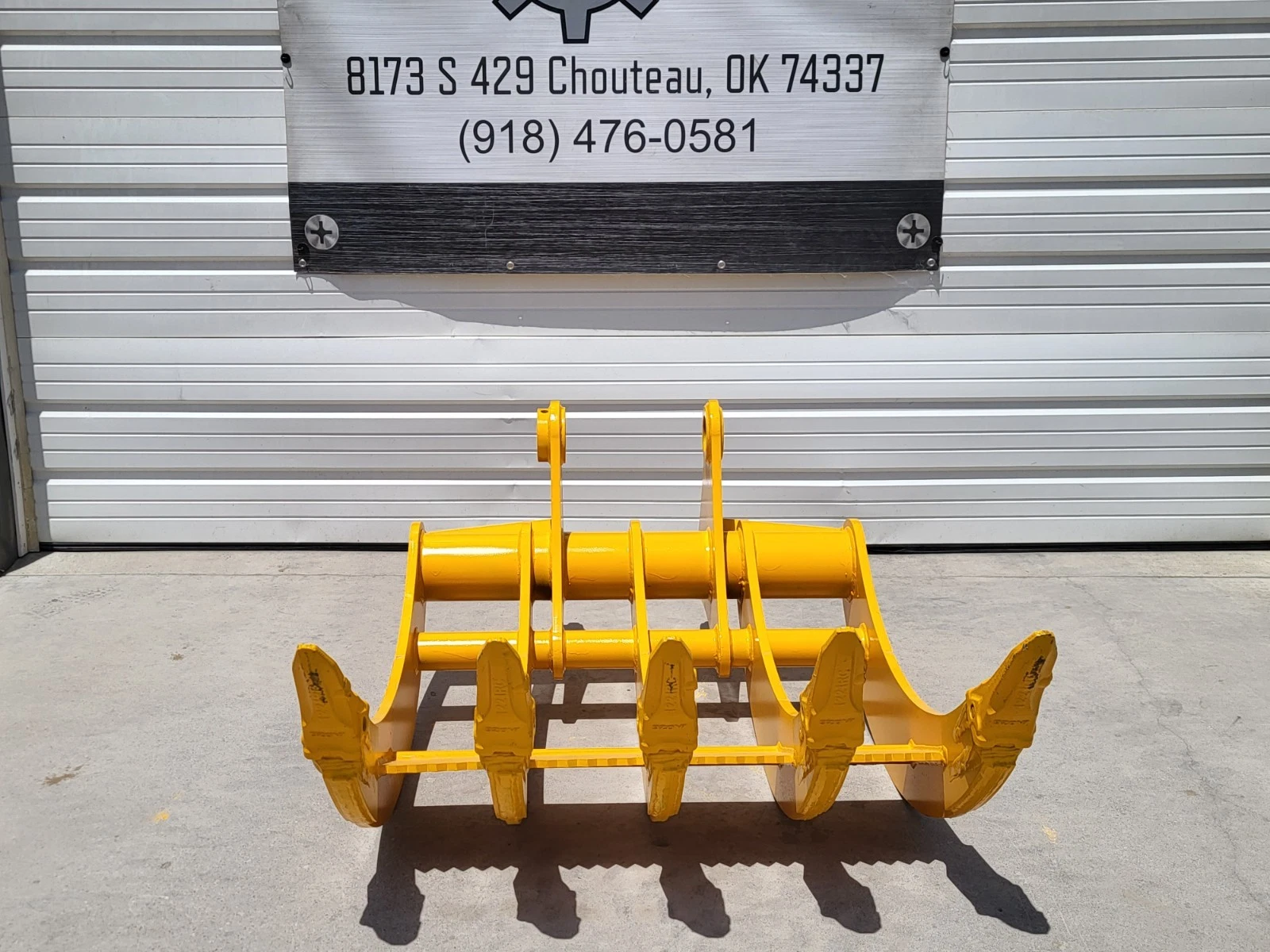 Yellow TOFT08R rake standing upright, five tine tips forward over a serrated bar, twin pin-boss arms
