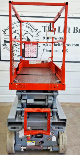 Skyjack S3219 platform deck from the end, red guardrails and roll-out extension deck over gray chassis