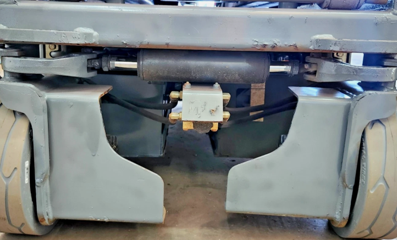 Skyjack S3219 undercarriage: steer cylinder and tie rod, brass hydraulic block, pothole guards, solid tires