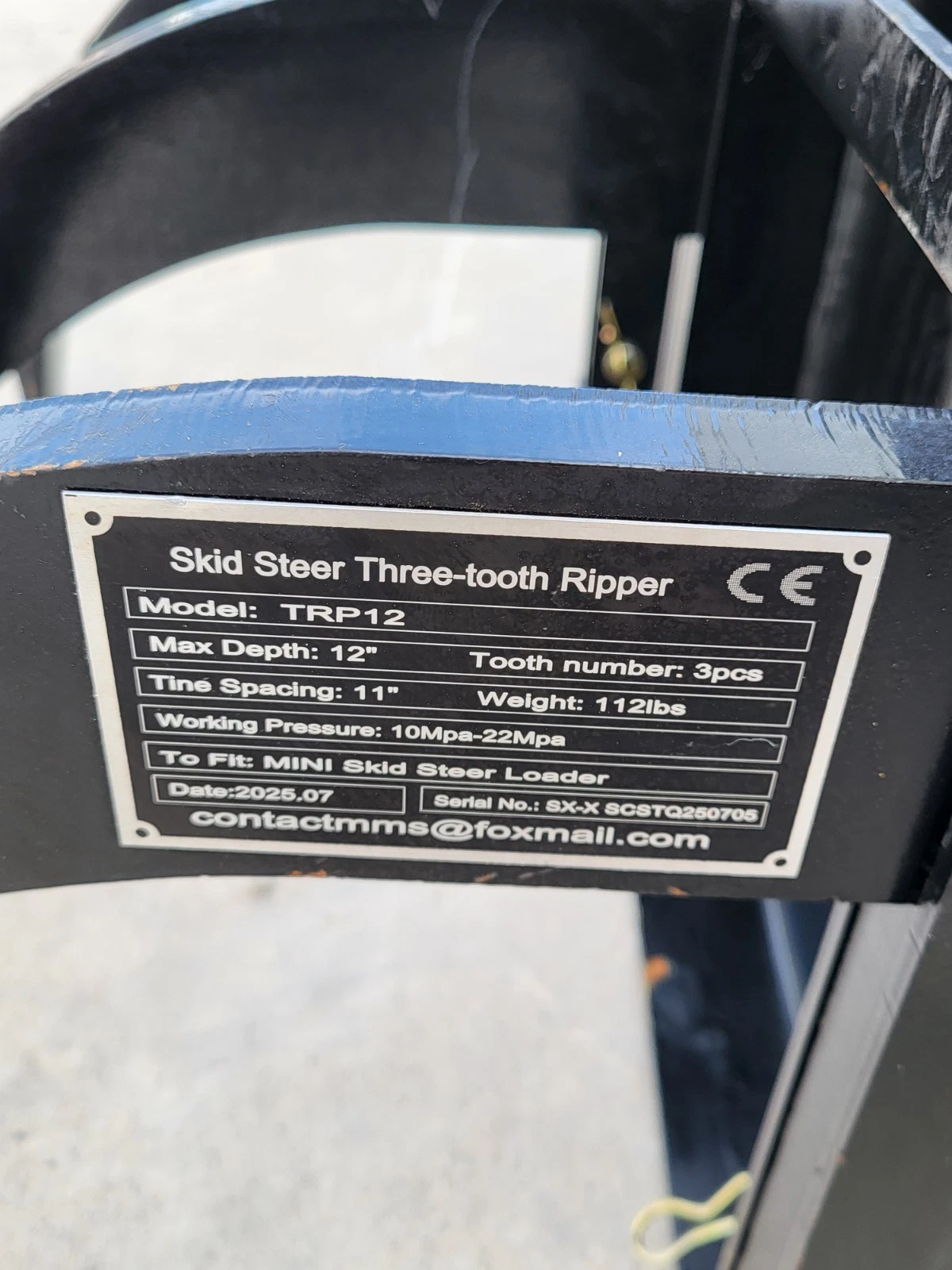 Data plate: Skid Steer Three-tooth Ripper, model TRP12, 12in max depth, 11in tine spacing, 112lbs