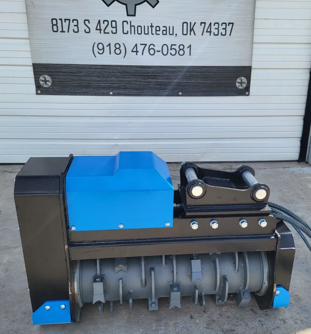 Blue Raytree excavator drum mulcher side-on: gray toothed rotor drum, blue housing and pin-on mount