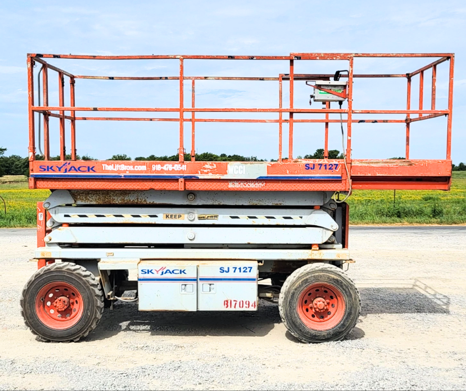 SkyJack SJ 7127 rough terrain scissor lift, orange guardrails and slide-out deck extension on lug tires