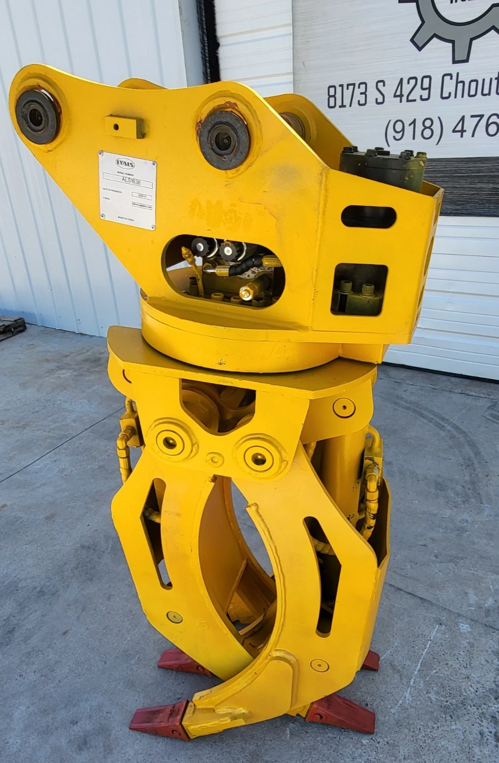 Yellow ALS1638 rotating grapple, pin-on mount head and rotator bearing above the open yellow tines