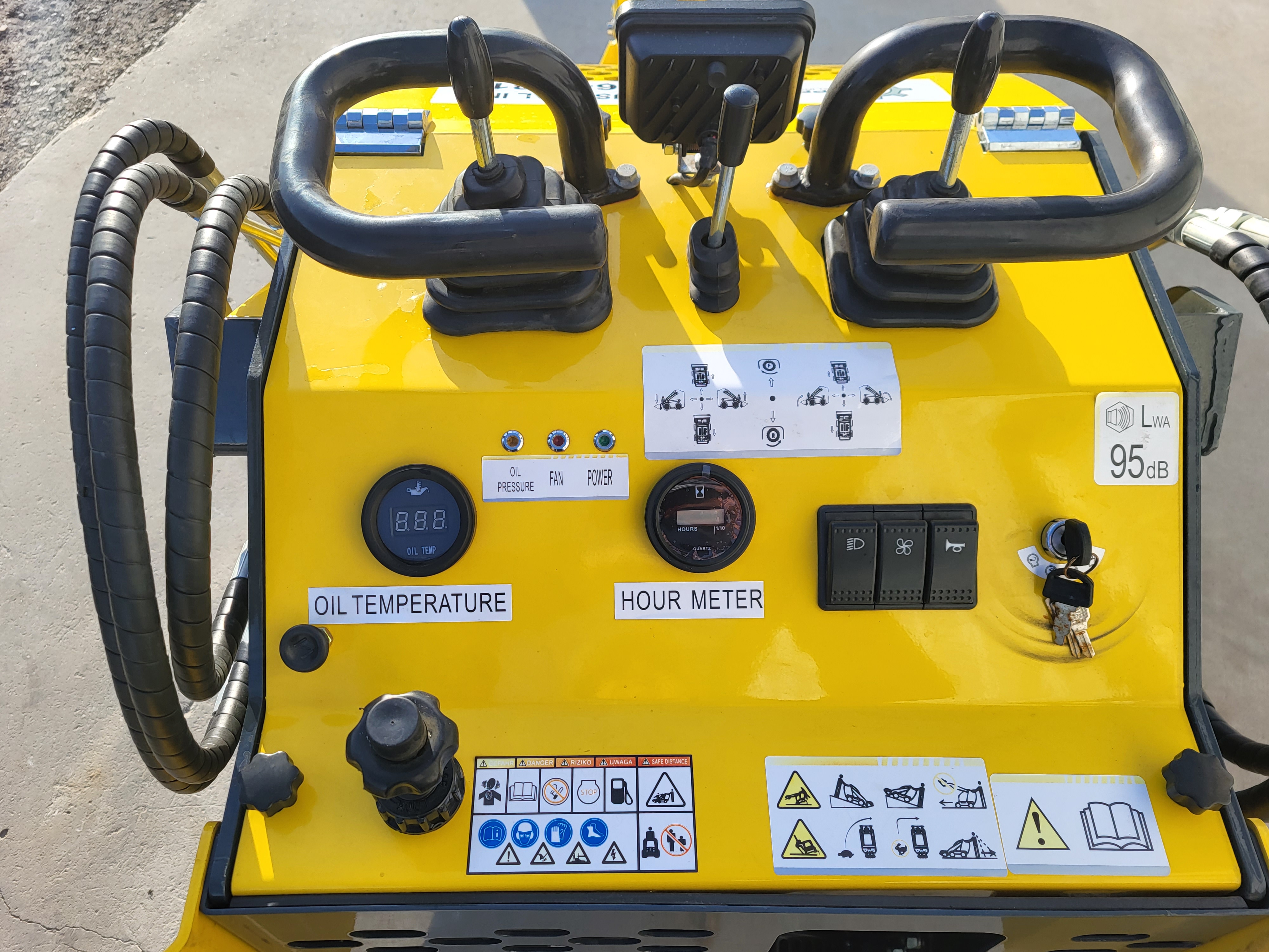 EG360 operator station: twin grab handles and control levers, oil-temperature gauge, hour meter, switches and key