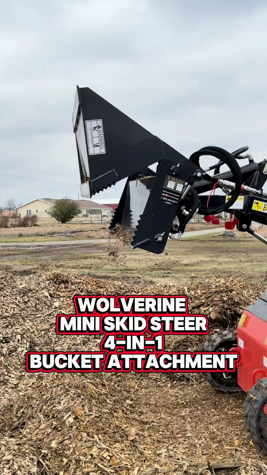 4-in-1 bucket's clamshell jaw open over a mulch pile, title text 'Wolverine Mini Skid Steer 4-in-1 Bucket Attachment'