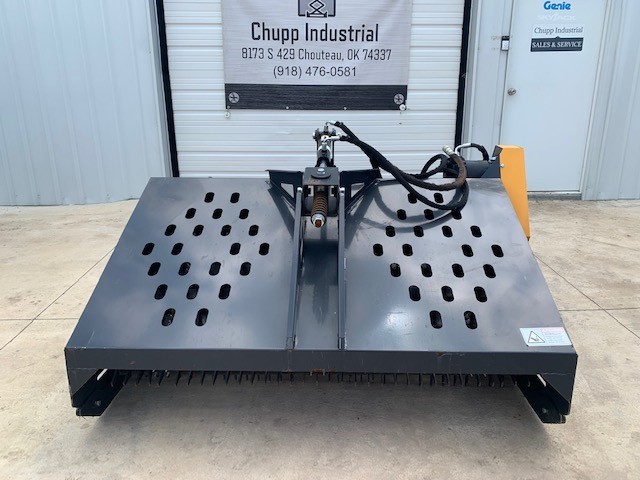 Gray hydraulic landscape rake front-on, twin slotted hopper decks, center mount with spring linkage, dense raking teeth below