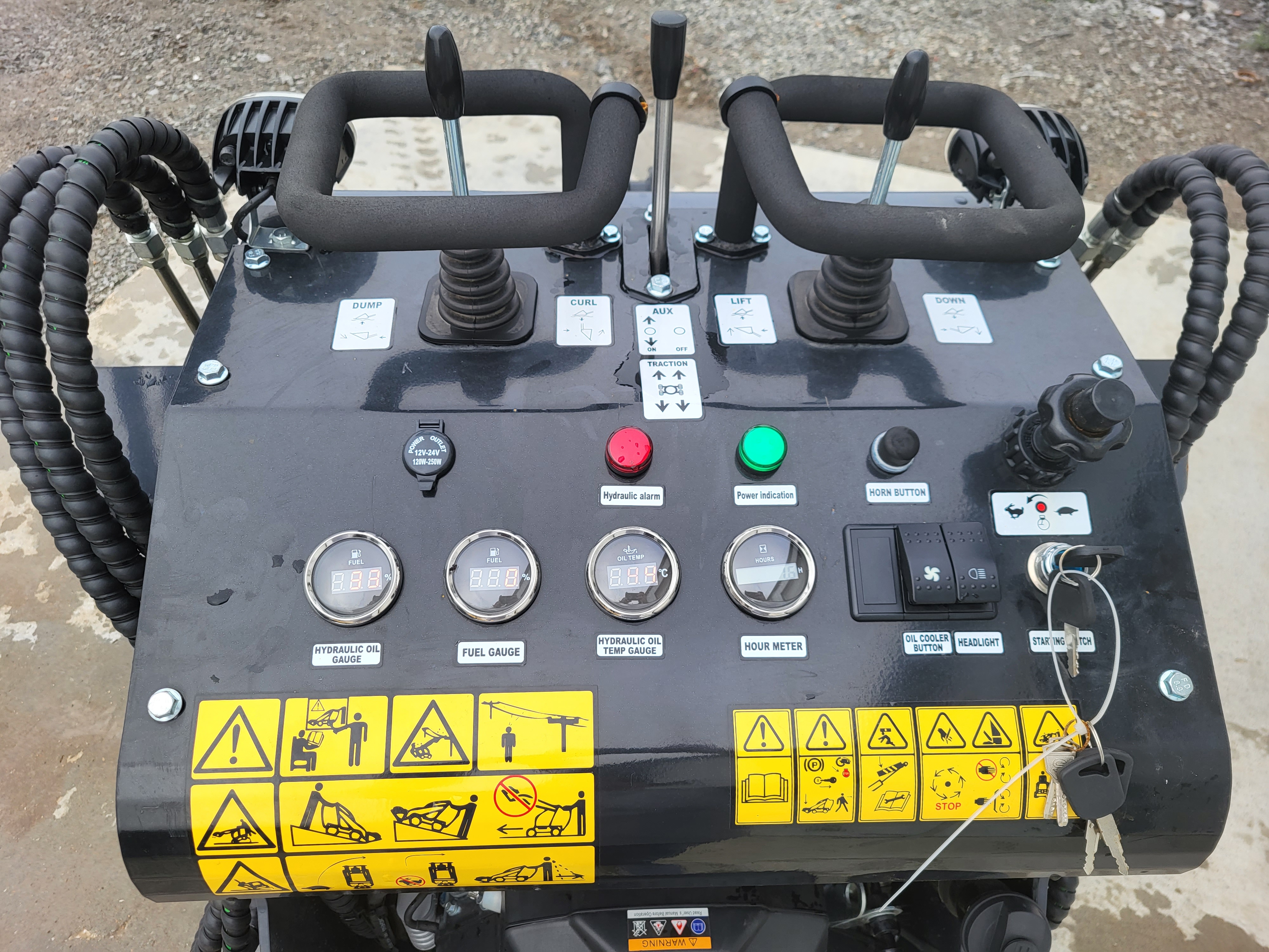 KRT23 control console: twin joysticks for lift, dump and curl, aux switch, fuel and hydraulic gauges, key start