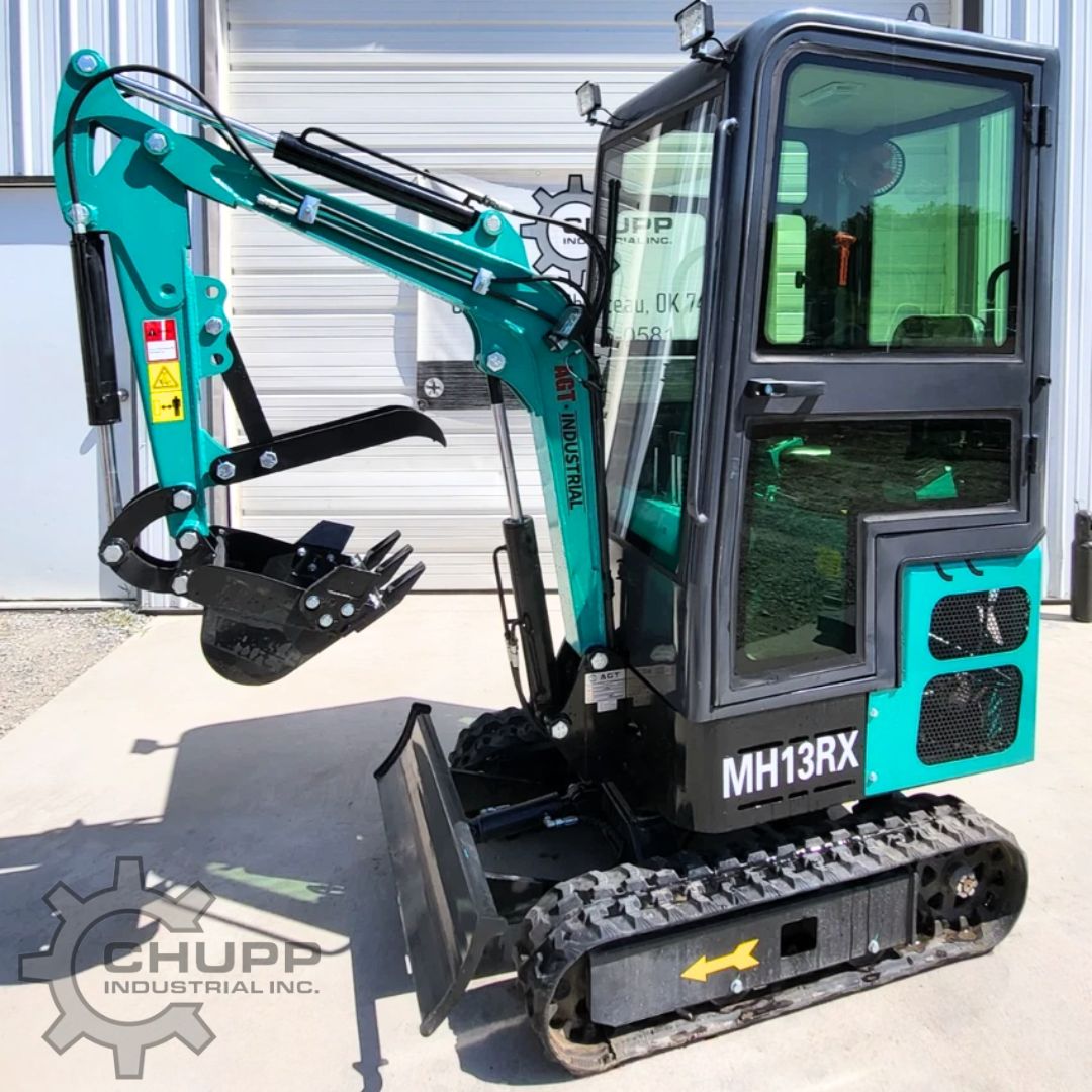 Teal MH13RX mini excavator with enclosed cab, toothed bucket and thumb, dozer blade and rubber tracks
