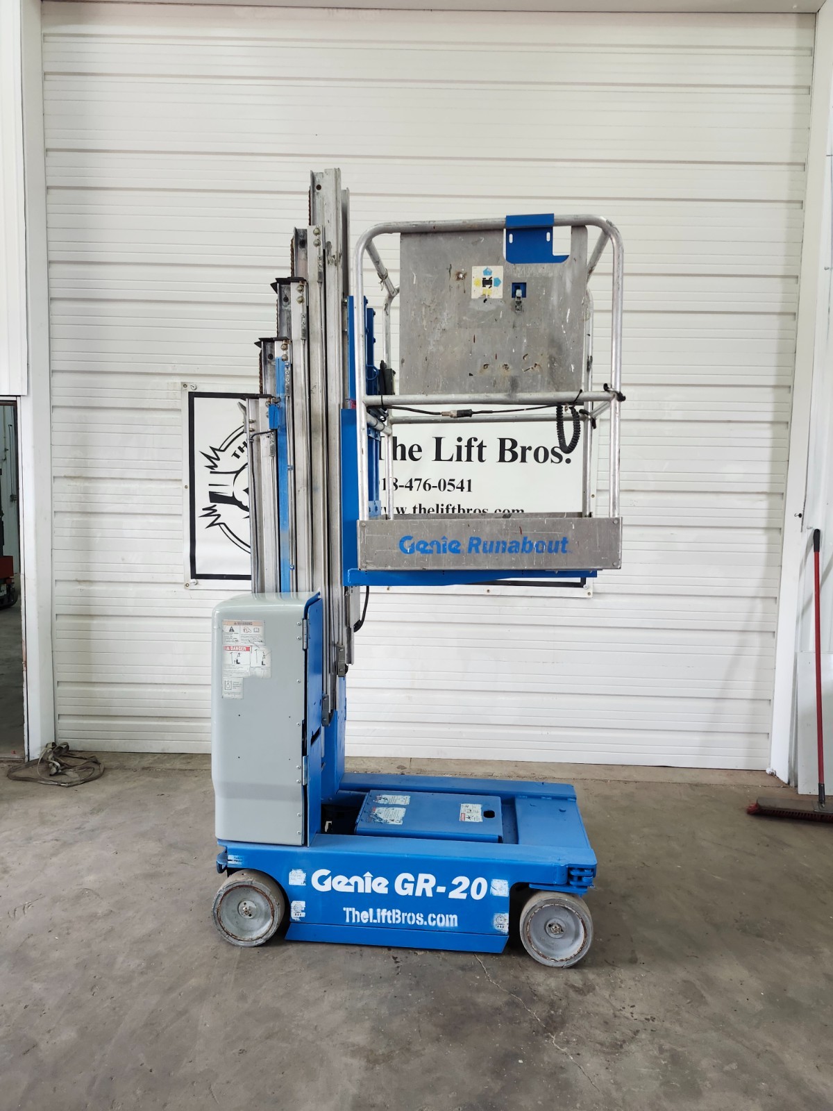 Blue Genie GR-20 Runabout vertical mast lift, side view, mast stowed, single-person platform