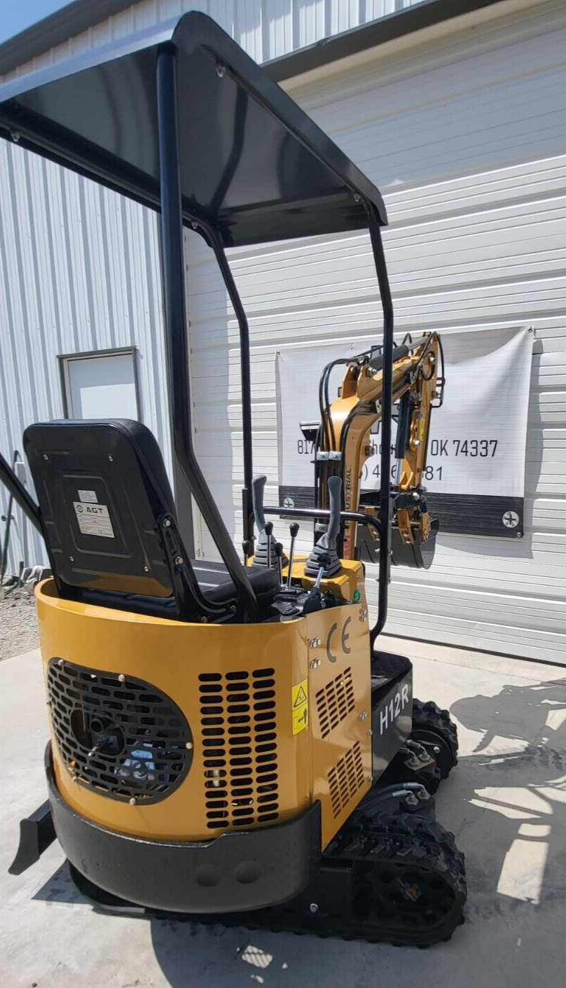 AGT H12R mini excavator operator station: seat under the canopy, joysticks and hand levers, vented engine cowl