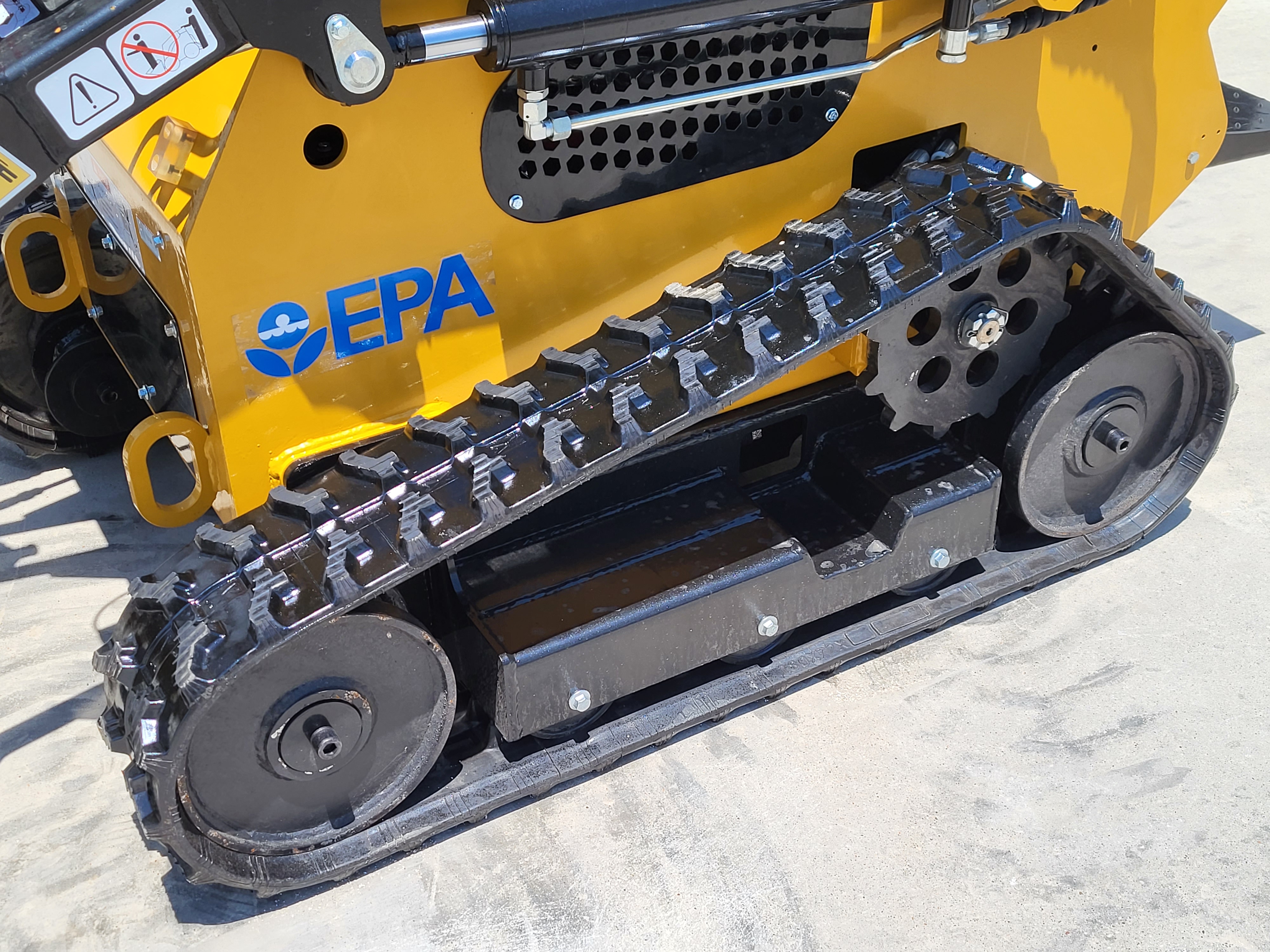 AGT CRT23 undercarriage: rubber track on the steel drive sprocket and idler wheels below the yellow chassis
