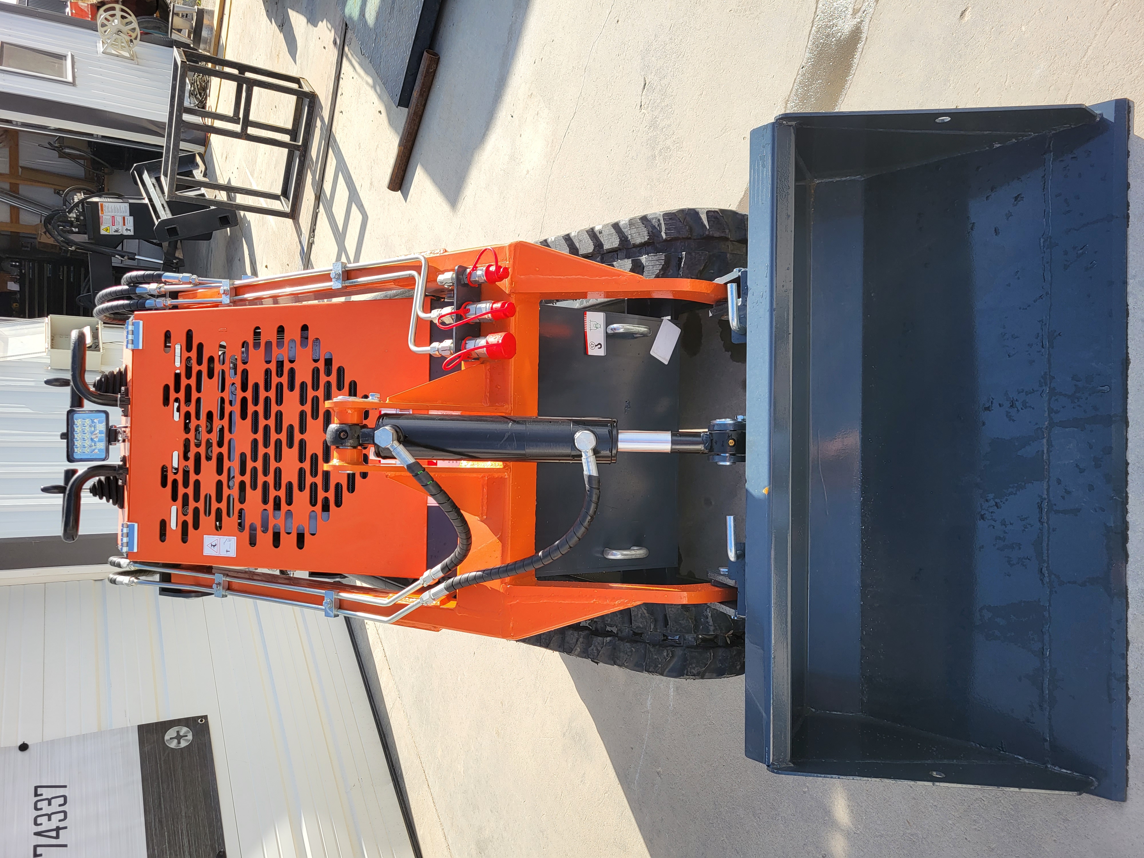 AGT YSRT14 mini skid steer with gray bucket, orange loader arms and front auxiliary hydraulic quick-couplers