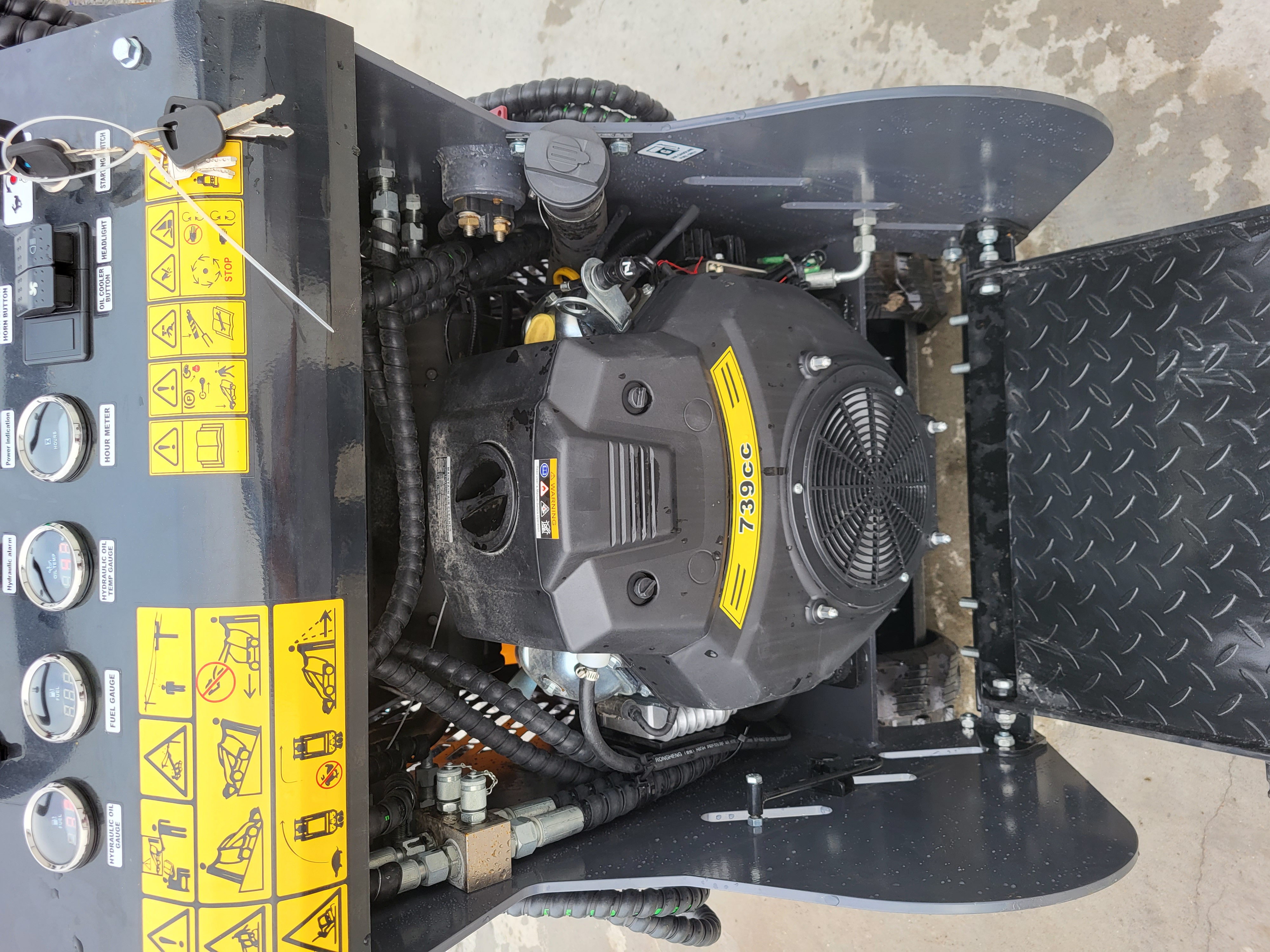 KRT23 controls and 739cc gasoline engine: hour meter, fuel and hydraulic oil gauges, horn and headlight switches
