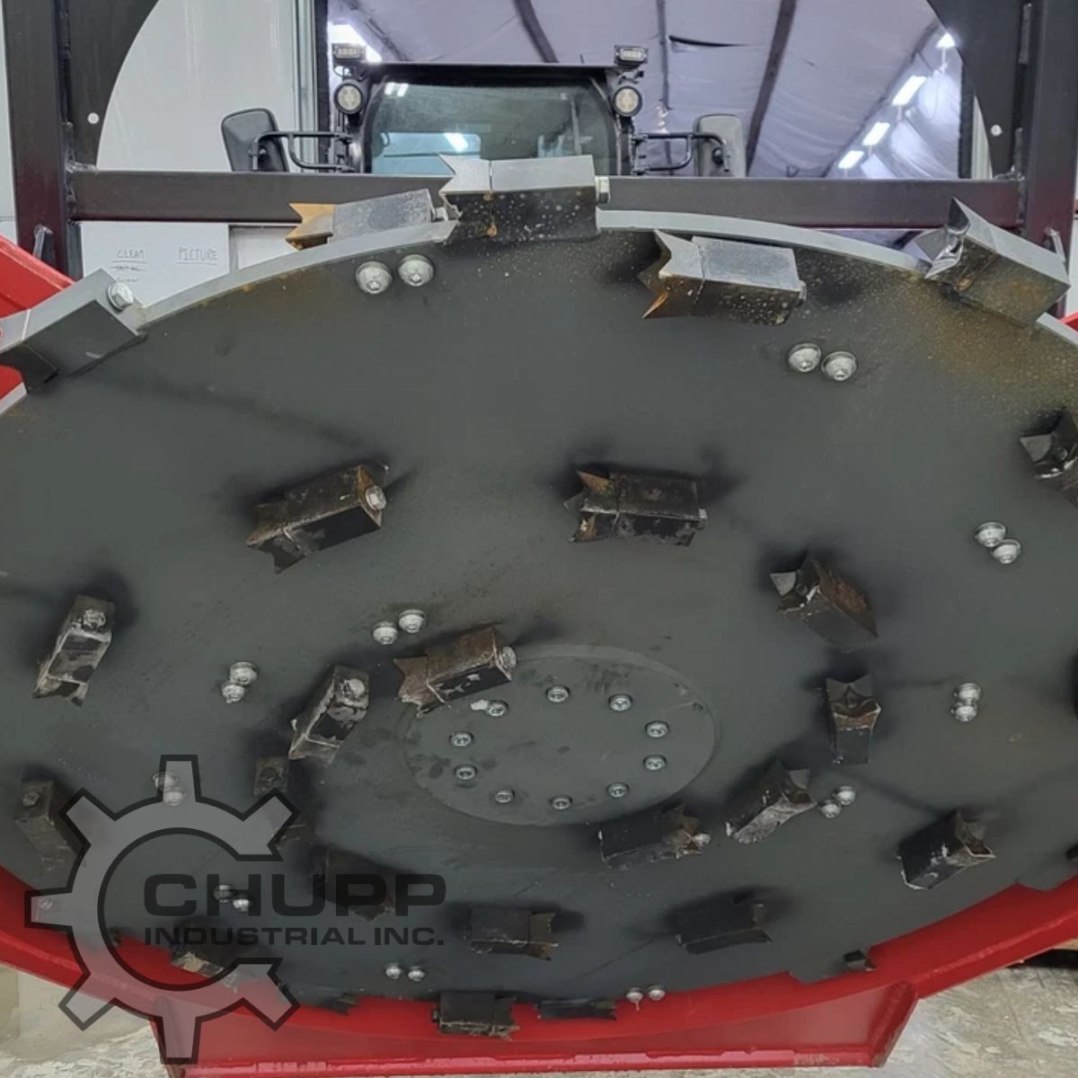 Disc mulcher cutter wheel face: bolt-on cutting teeth spread across the steel disc around a bolted center hub