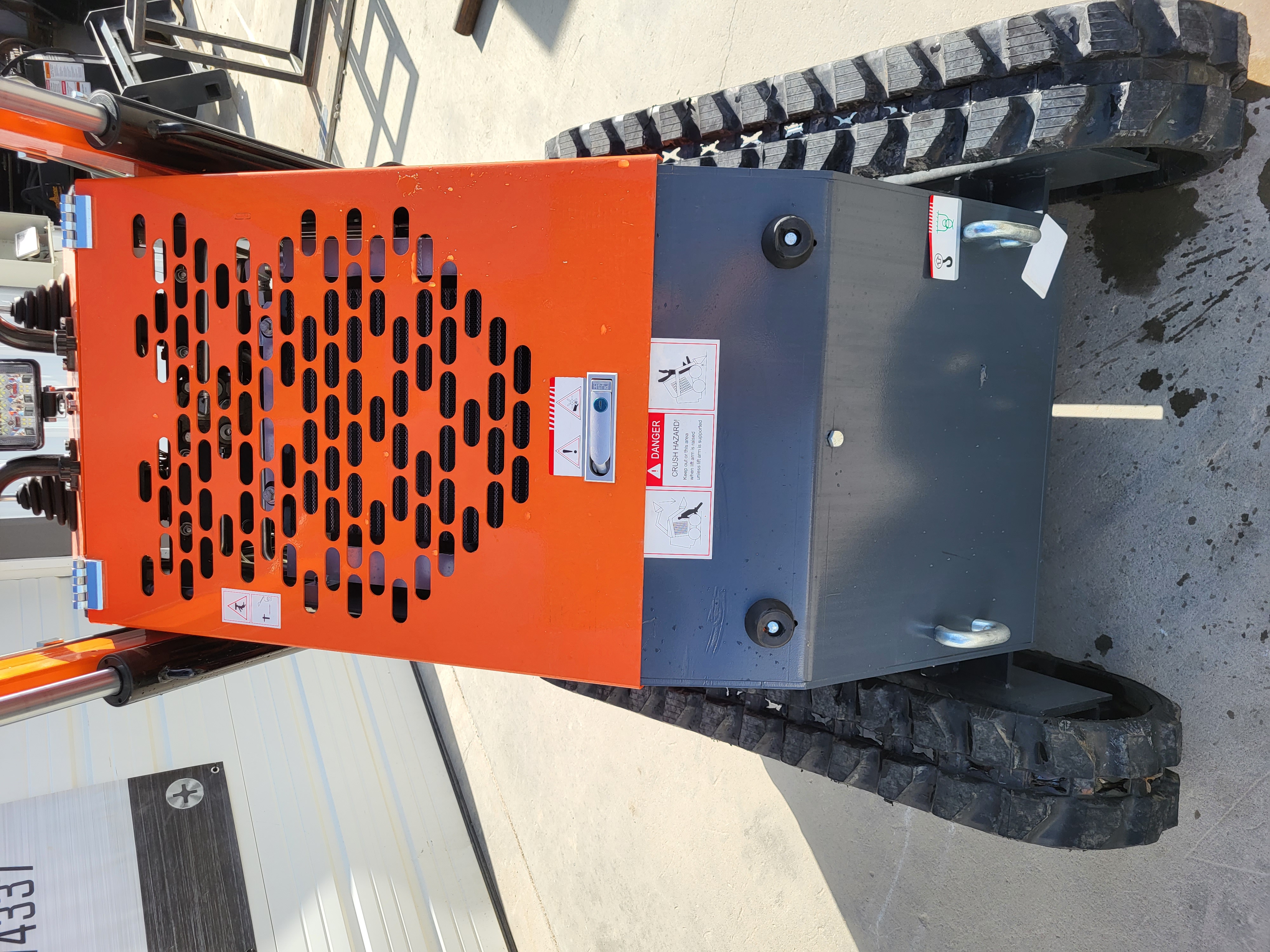 AGT YSRT14 mini skid steer from behind: vented orange engine cover, gray rear panel with lifting eyes and rubber tracks