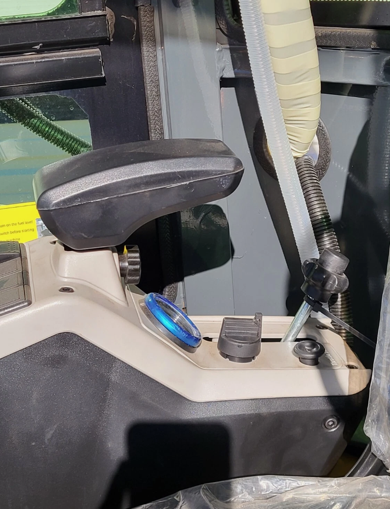 QK18RXS-C right-hand console: padded armrest, throttle and control knobs beside the cab air-conditioning duct