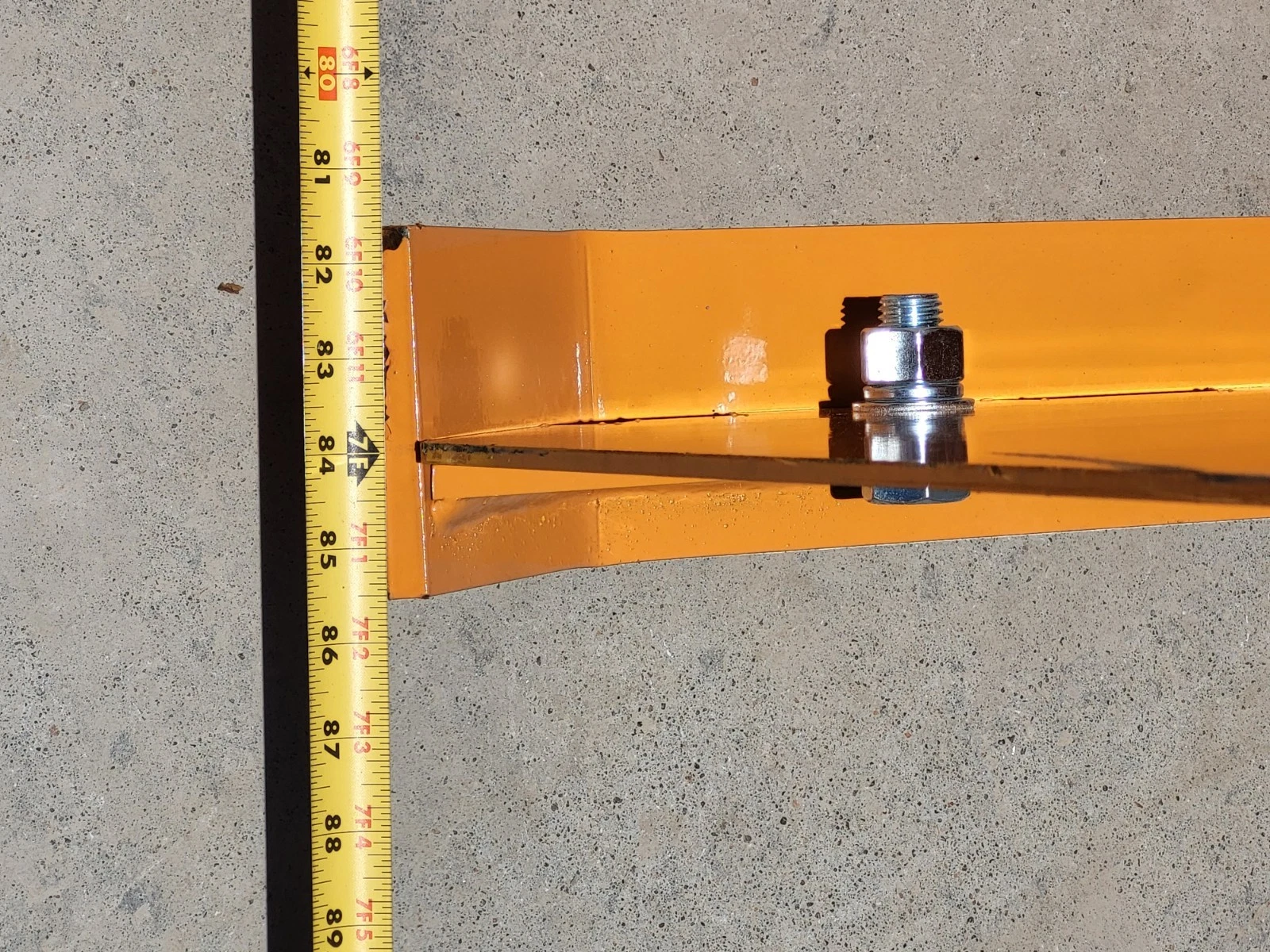 Tape measure at the end of the snow blade, the blade edge falling at about 84 inches