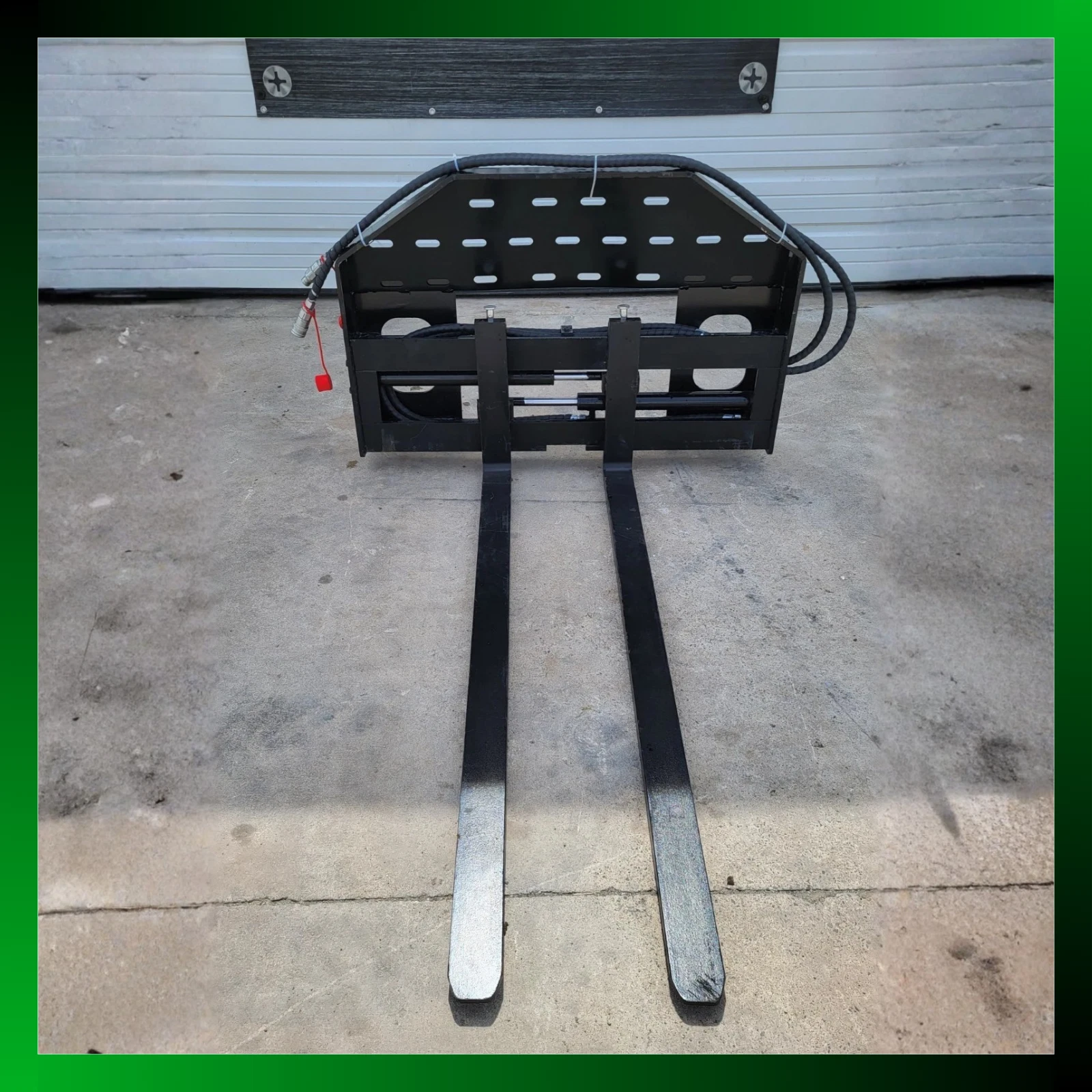 60-inch pallet forks straight on inside a green photo border, forks extended, hoses over the backrest