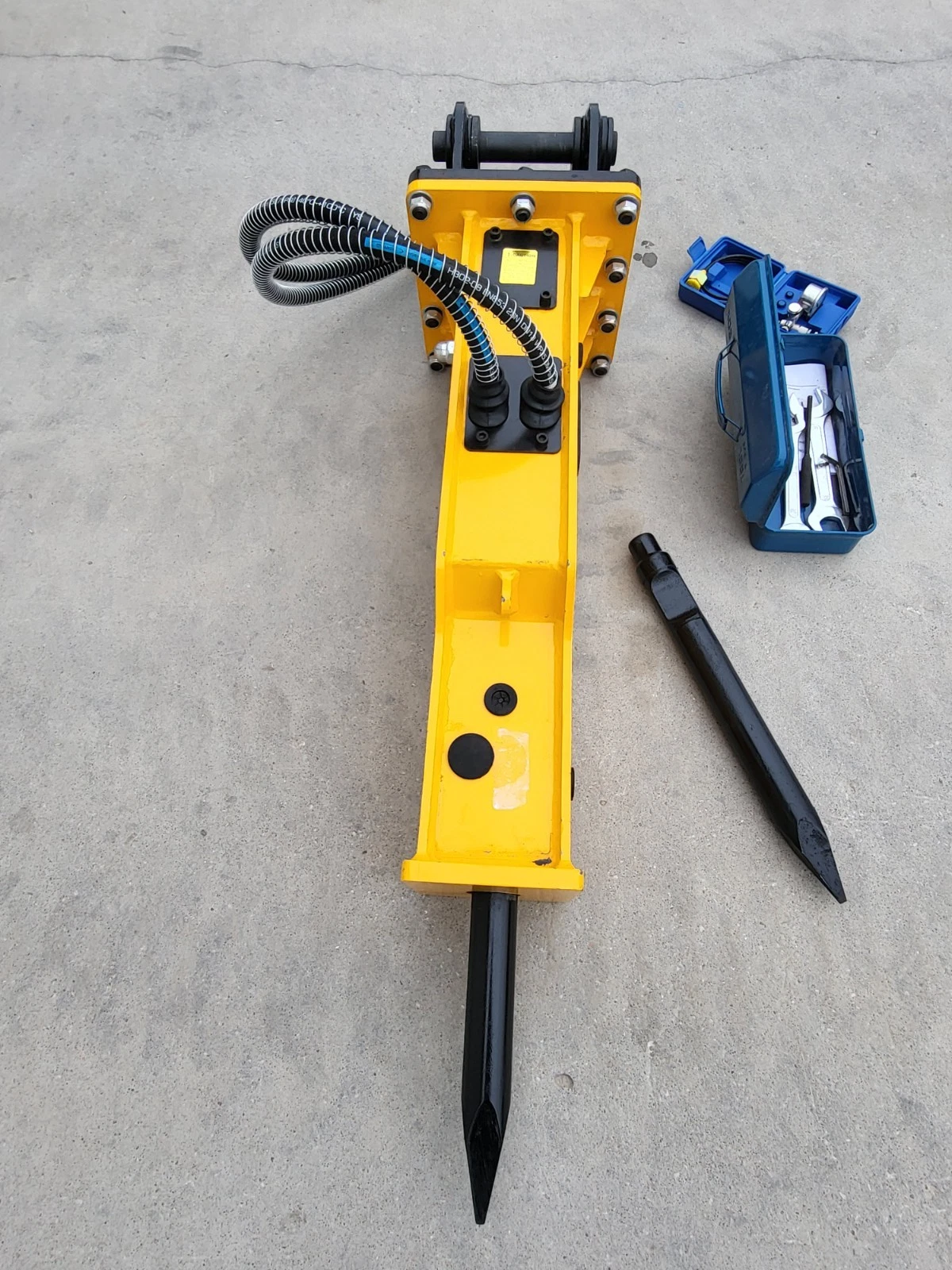 TOFT530 yellow breaker upright with moil point fitted, sleeved hoses, spare chisel and open wrench box