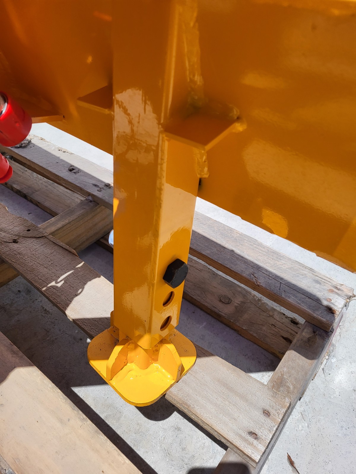 Base of the post driver: square shaft with pin holes, a hex bolt and the domed driver head