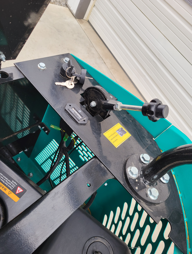 WH12R control panel with key ignition switch, throttle lever and exposed swing drive gear