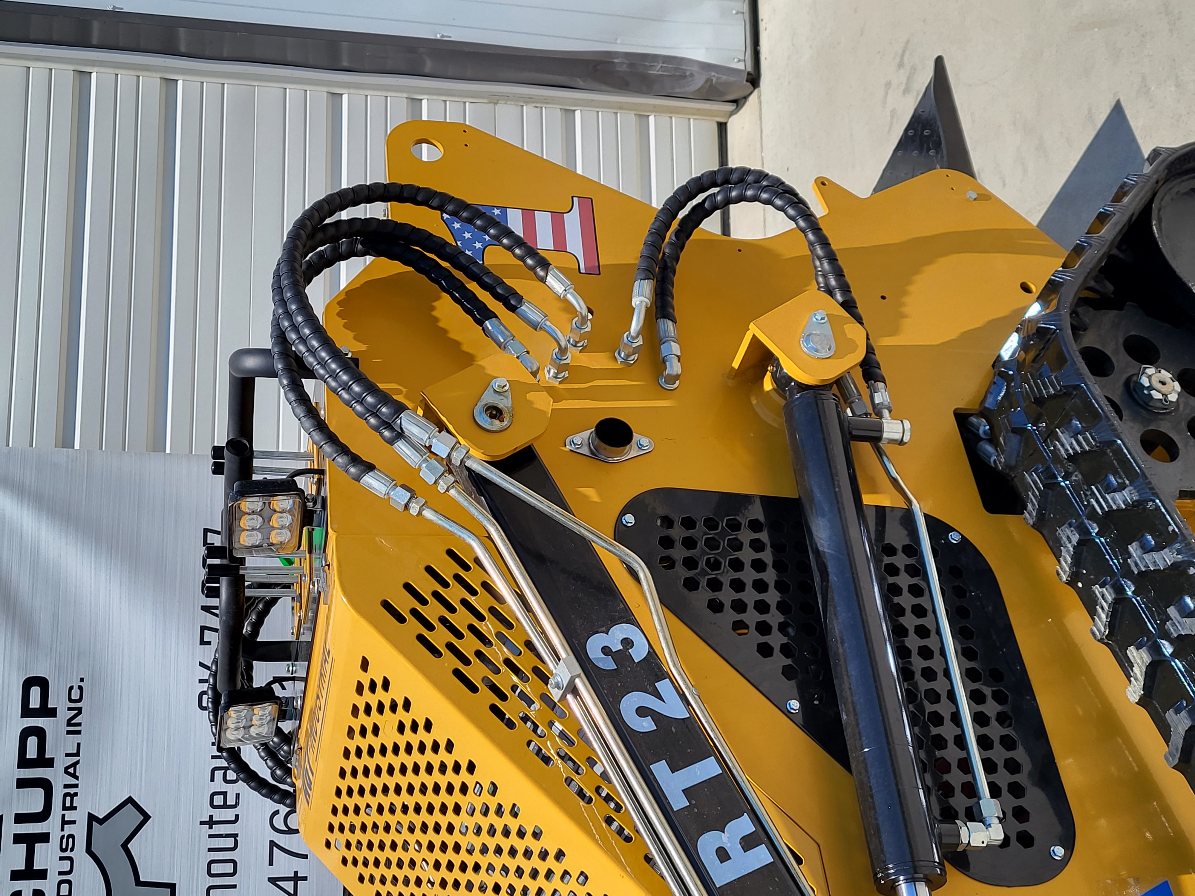 AGT CRT23 loader arms: braided hydraulic hoses running to the lift cylinders, LED work lights and perforated hood