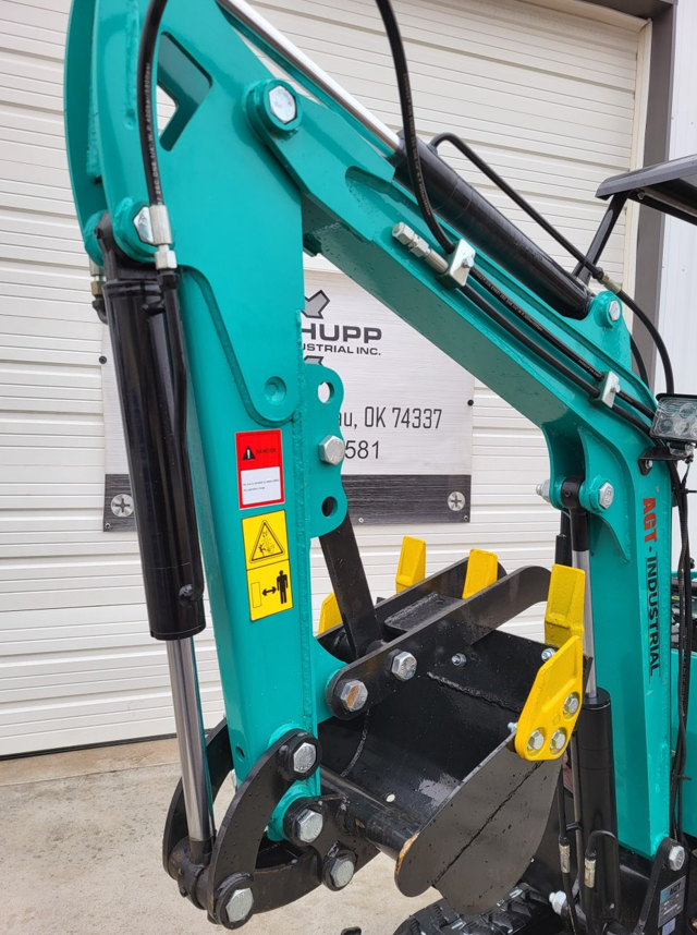 WH12R mini excavator boom and dipper arm in teal with black digging bucket and yellow hydraulic thumb