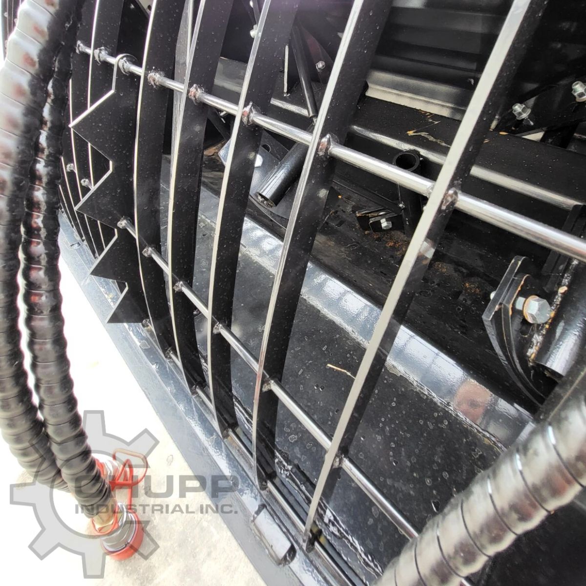 AGT cement mixer bucket, steel bag-cutter grille bars over the mixing paddles inside the drum, hydraulic hoses
