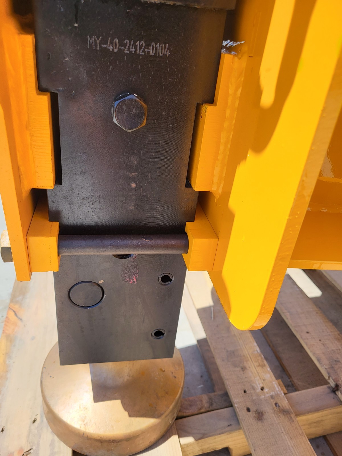 Post driver lower housing and shaft: cross pin, mounting holes and the domed driver head at the base