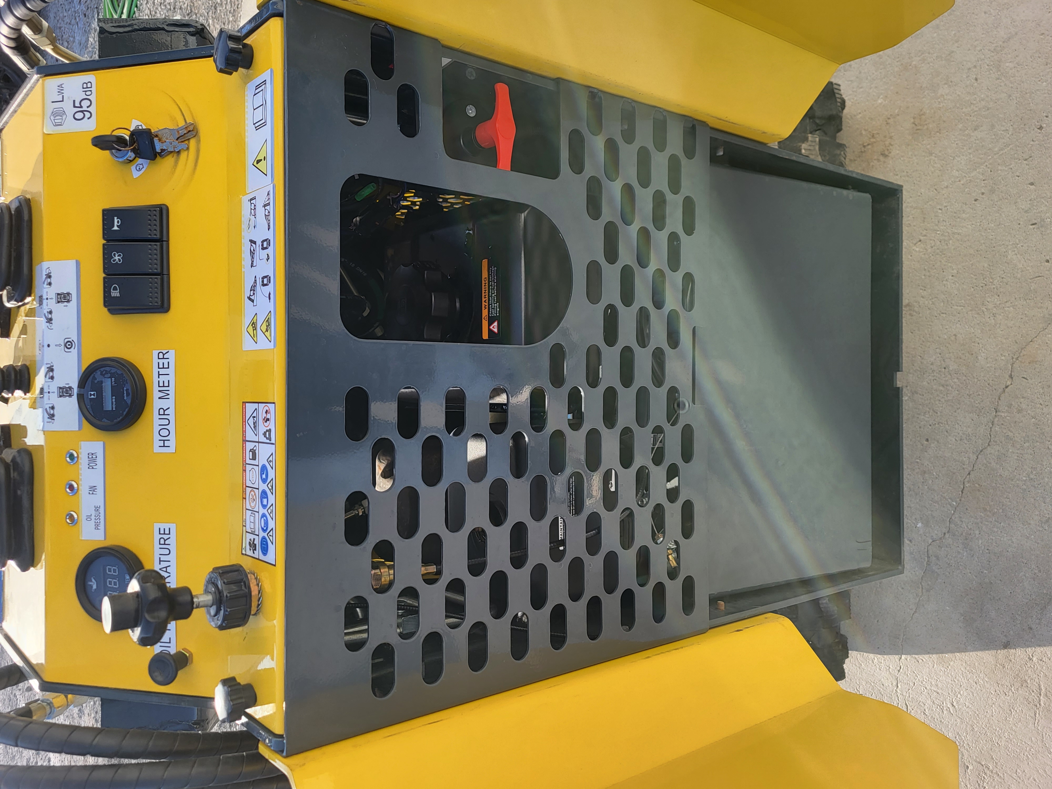 EG360 control panel: hour meter, oil-temperature gauge, light/fan/horn switches and key ignition on the yellow console