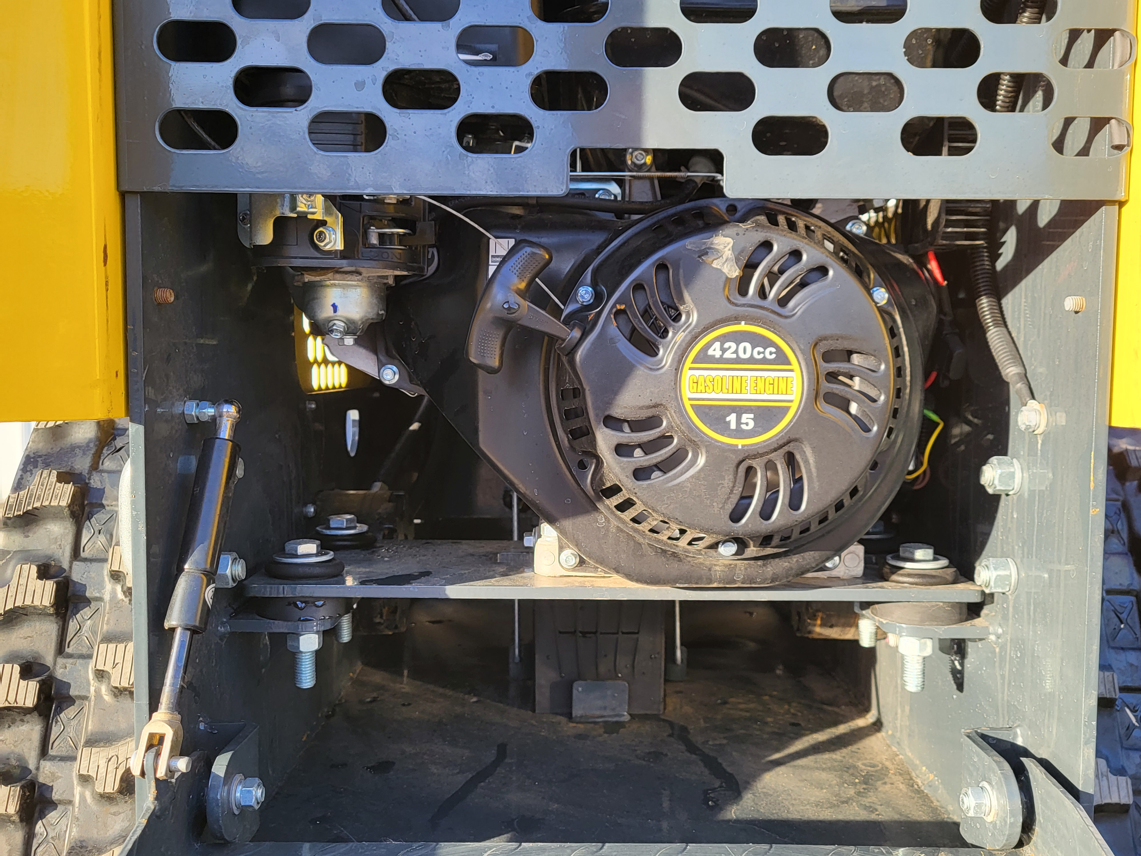 EG360 engine bay: 420cc gasoline engine with recoil starter behind the perforated guard, above the rubber track
