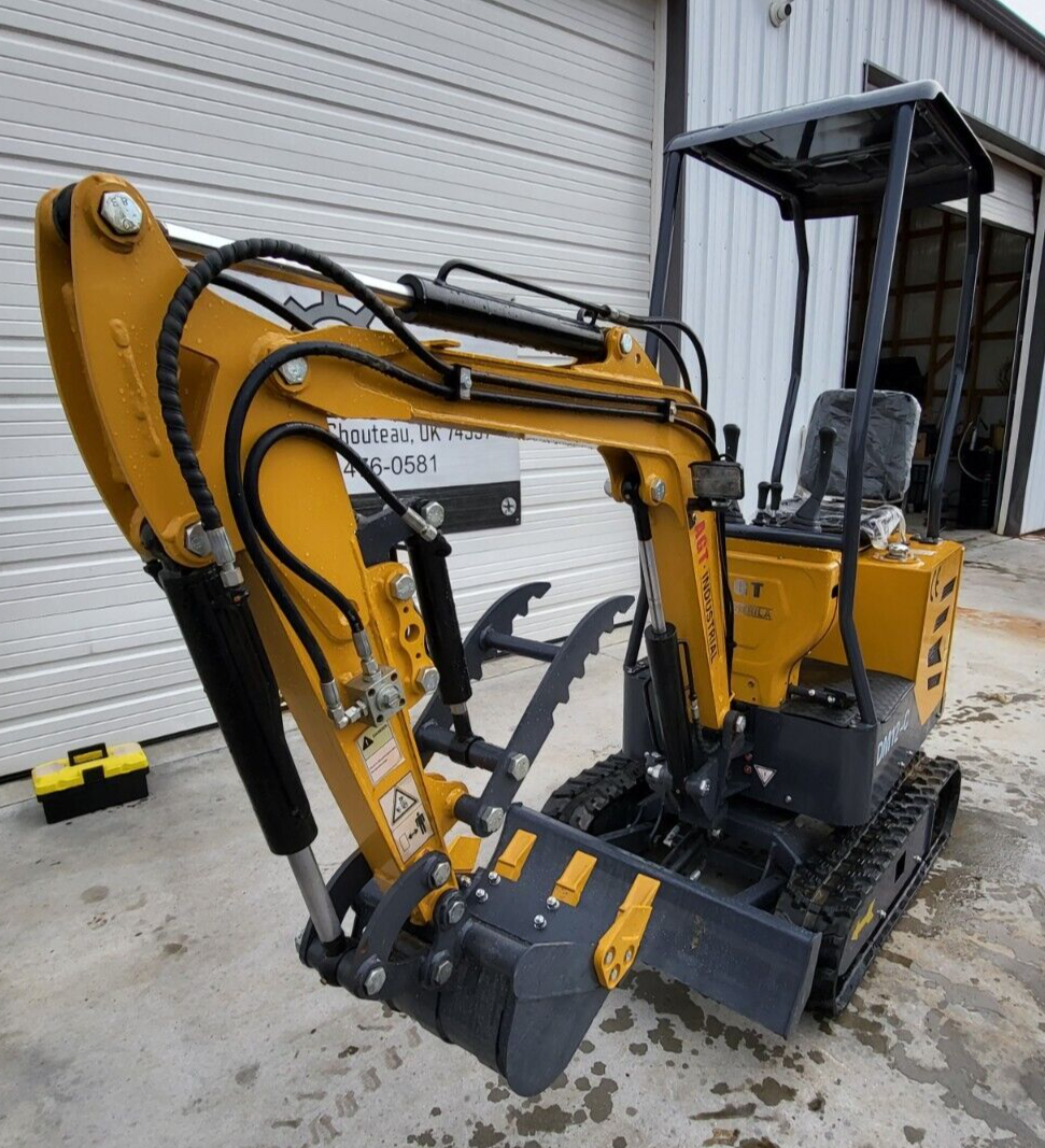 AGT DM12-C mini excavator, boom folded in: hydraulic thumb over the digging bucket, backfill blade down, canopy and seat