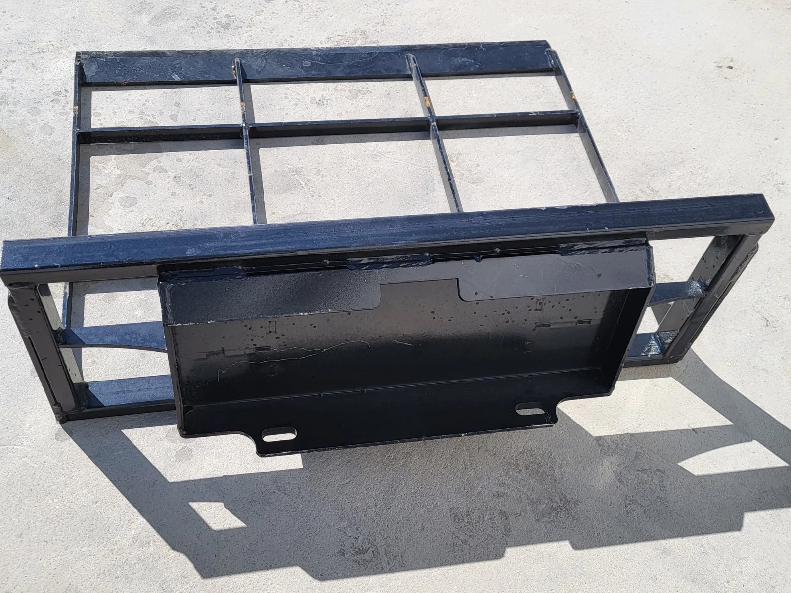 Land leveler from behind: universal quick-attach mount plate welded to the open grid frame