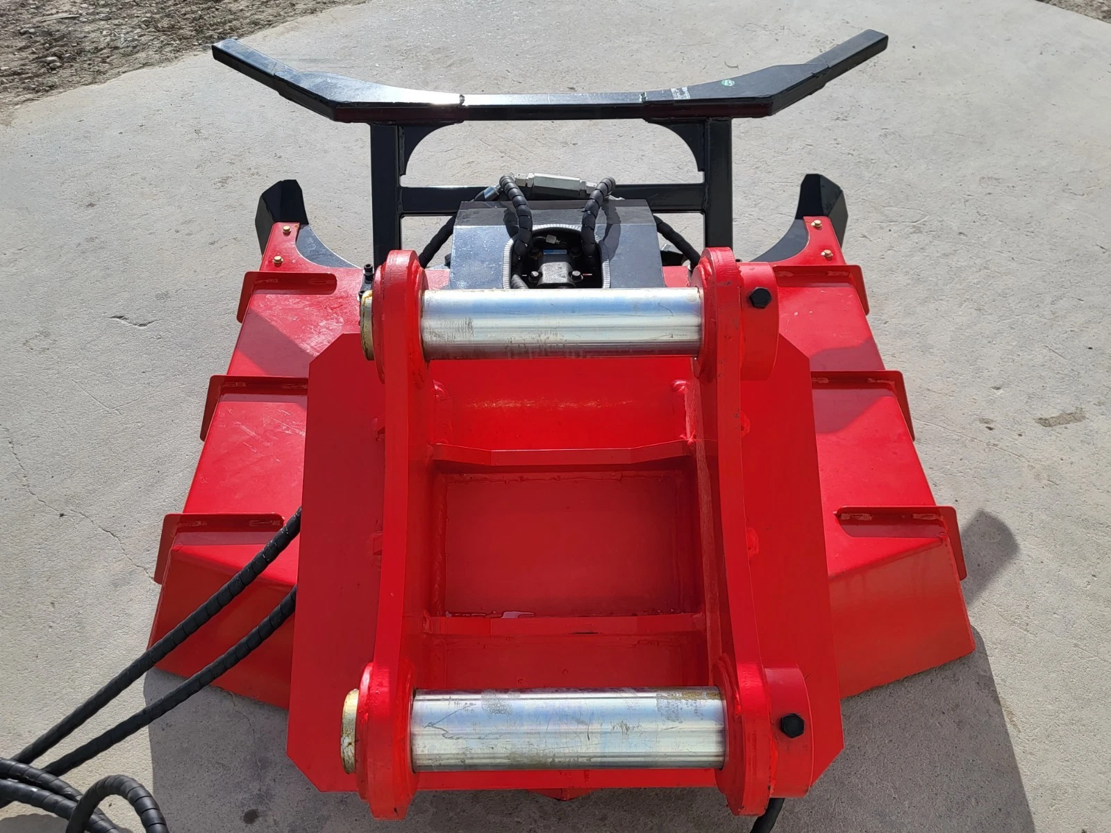 Red Captok disc mulcher from above: twin mounting pins, black push bar and hydraulic motor