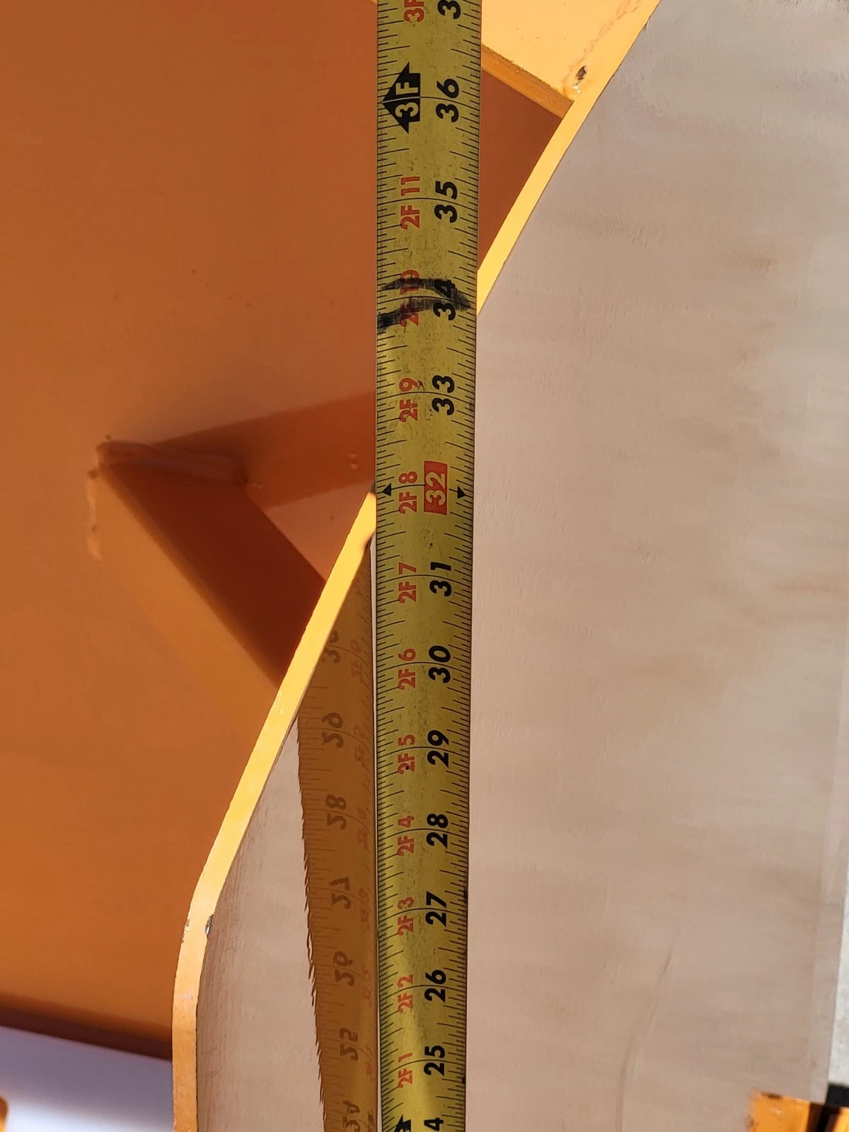 Tape measure up the snow blade's end plate, reading about 32 inches of overall height
