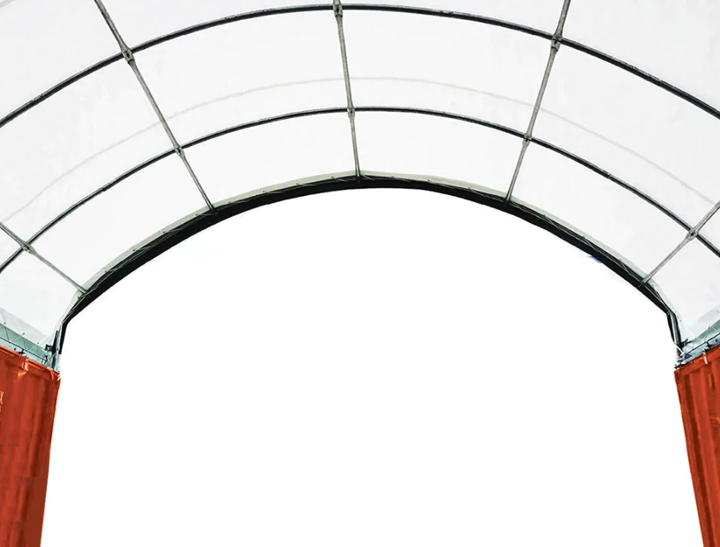 Container shelter's white PVC arch on galvanized tubing, spanning the gap between two shipping containers