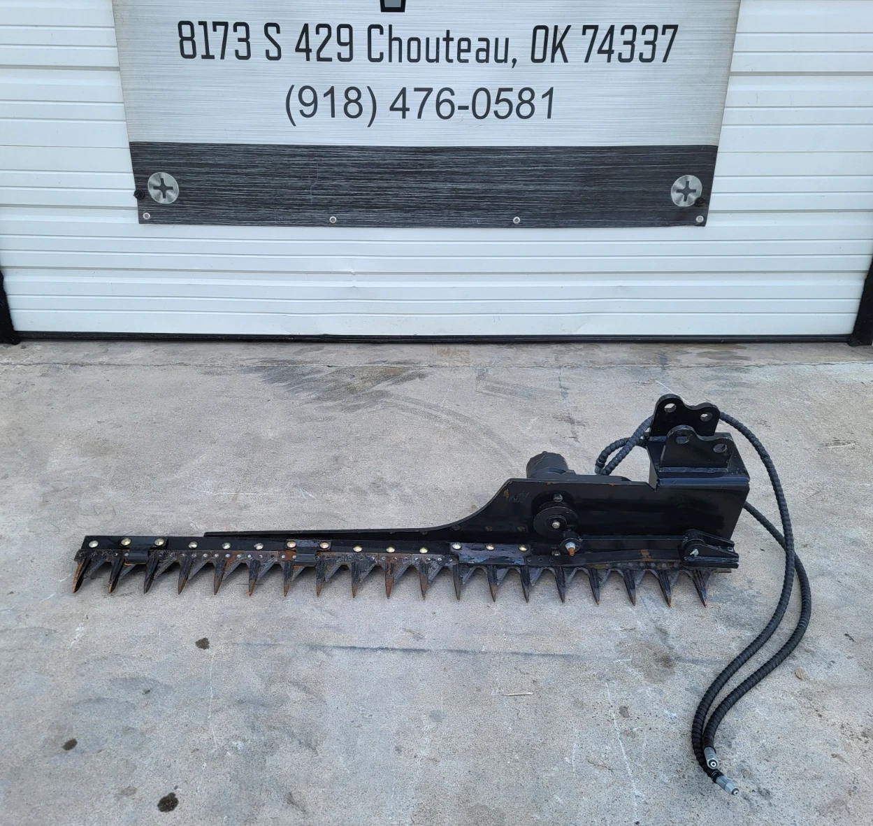 58-inch sickle mower bar laid flat: pointed cutter guards, drive motor, pin-on mount head and hoses