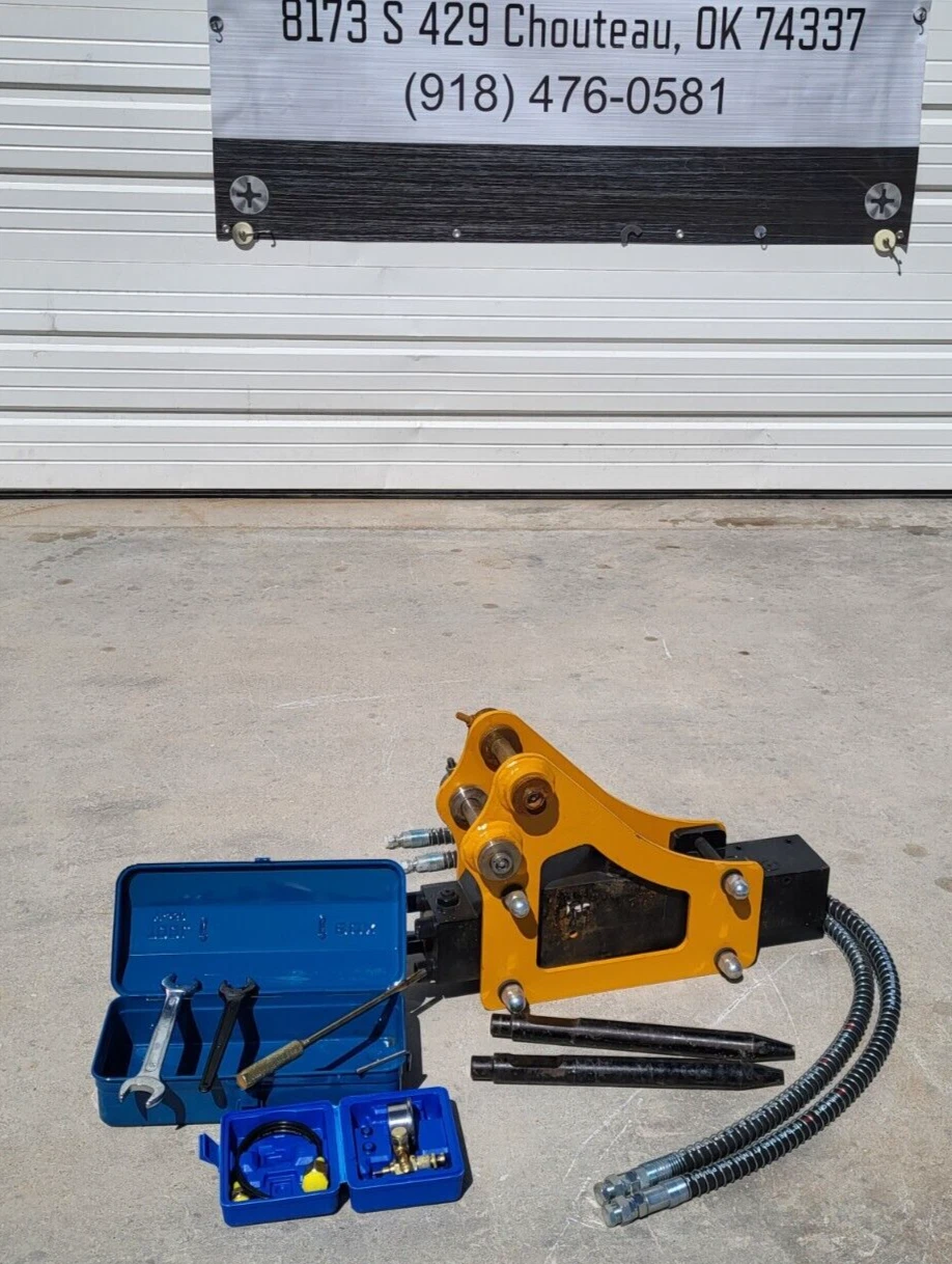 Yellow and black hydraulic breaker with two chisels, tool box, nitrogen charging kit and hydraulic hose