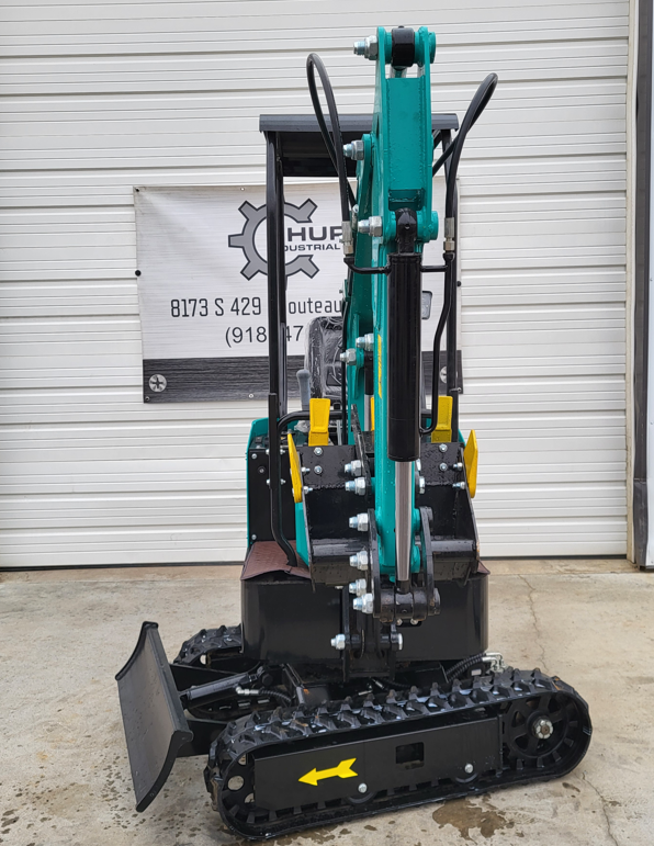 Teal WH12R mini excavator, front on, with raised boom, hydraulic hoses, backfill blade and rubber tracks