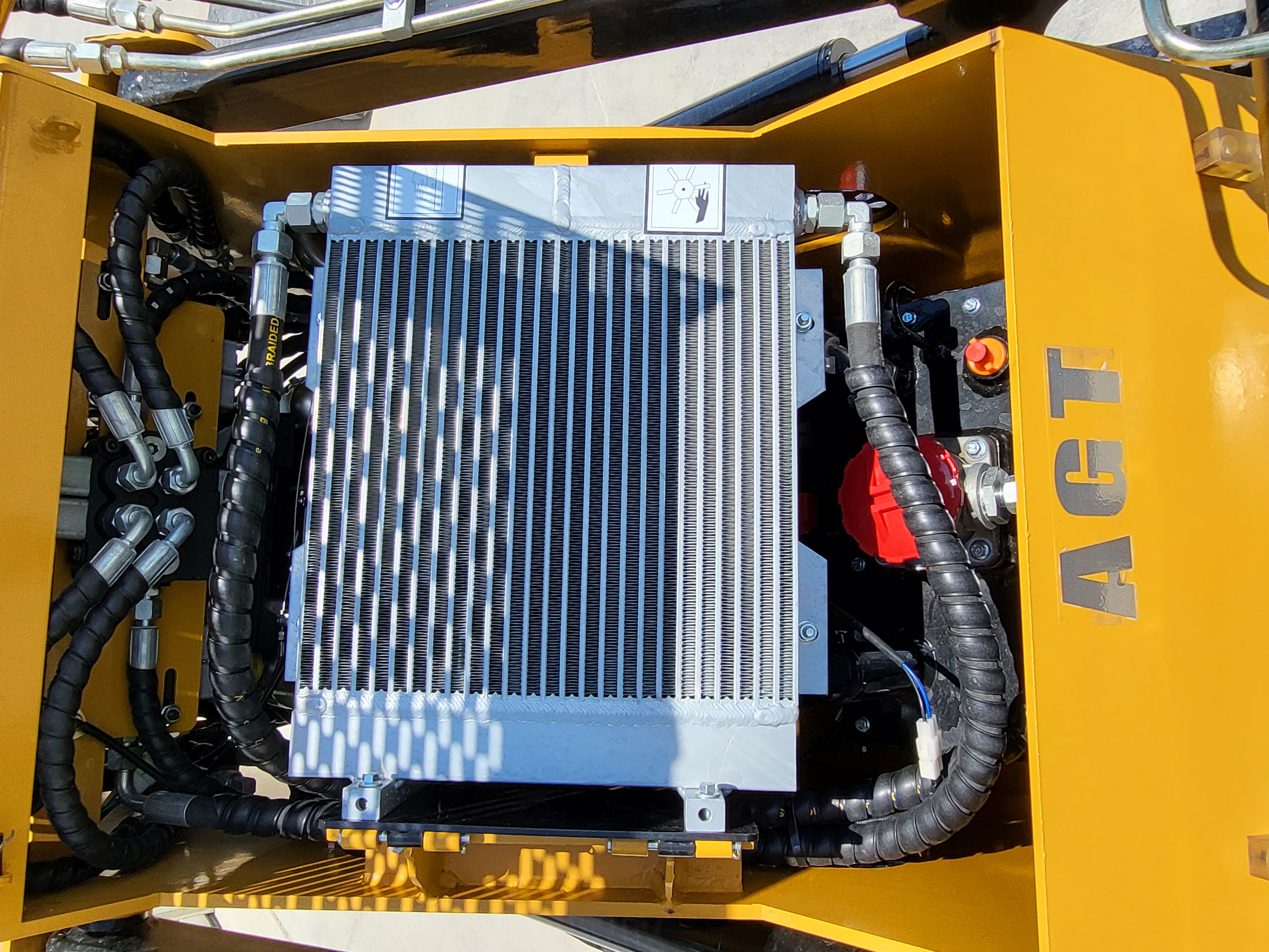 AGT CRT23 hydraulic oil cooler: finned aluminum cooler with braided hoses and red fill cap inside the yellow frame