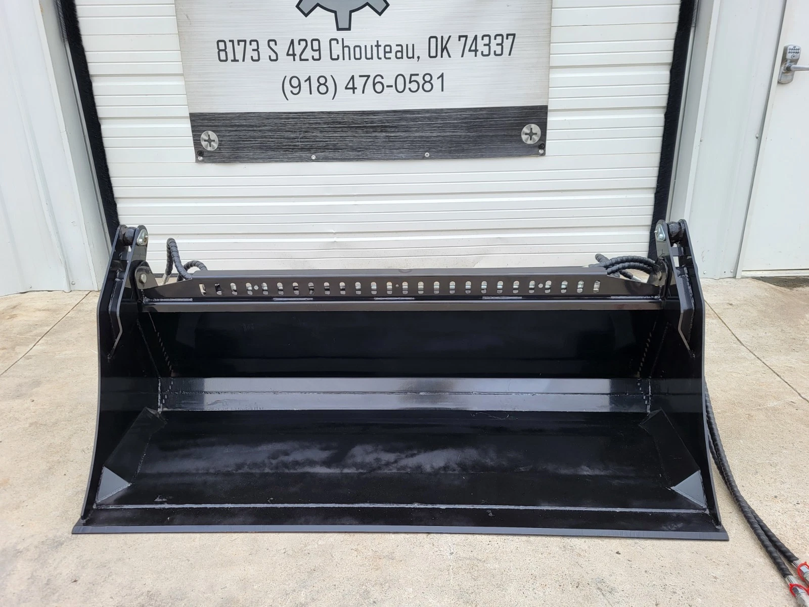 72-inch 4-in-1 skid steer bucket with the clam open, slotted top rail and flat cutting edge