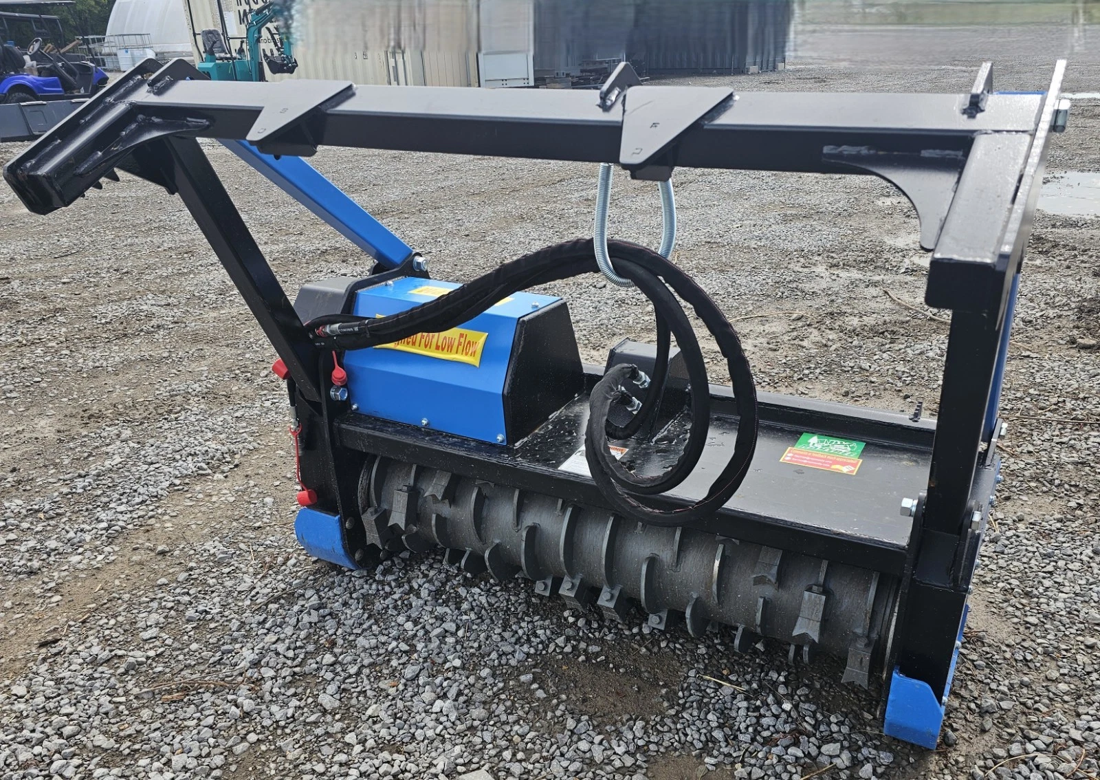Raytree drum mulcher on the quick-attach frame, blue motor housing and black toothed drum rotor